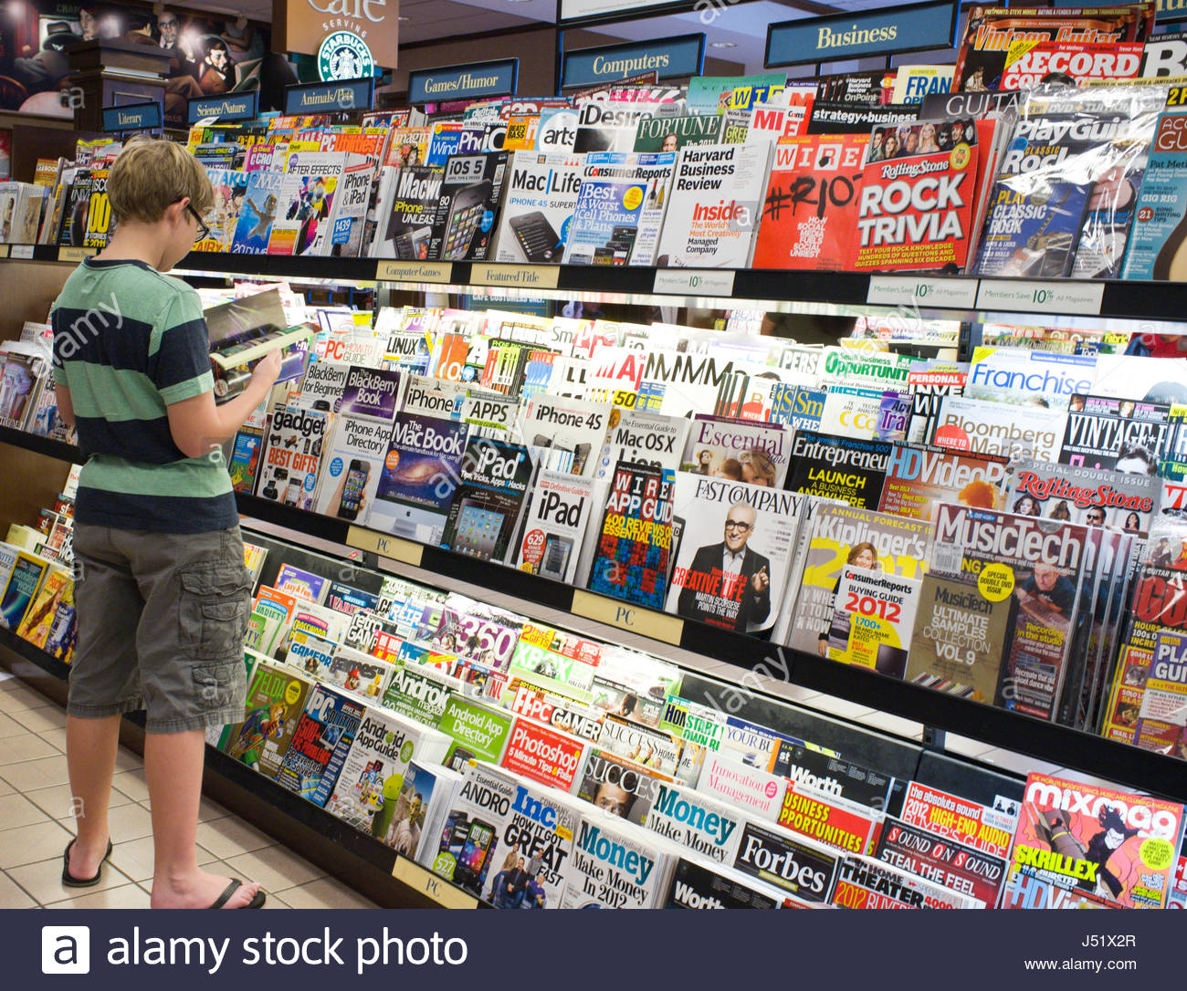 Teenage Caucasian Boy Reading A Magazine At A Barnes Noble Stock