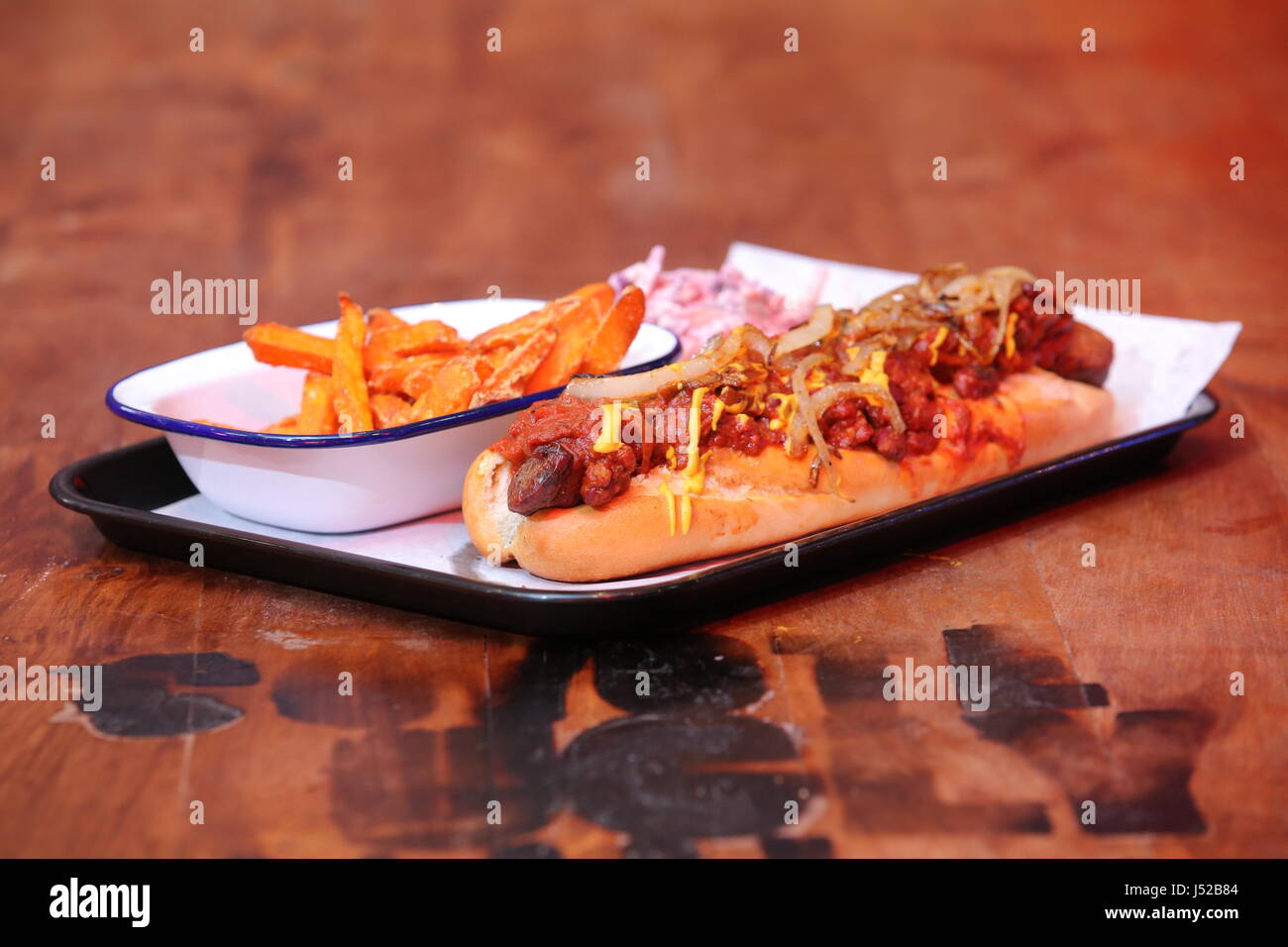 A hot dog dish with coleslaw and sweet potato chips Stock Photo Alamy