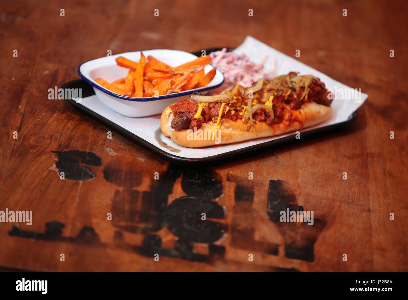 A hot dog dish with coleslaw and sweet potato chips Stock Photo Alamy