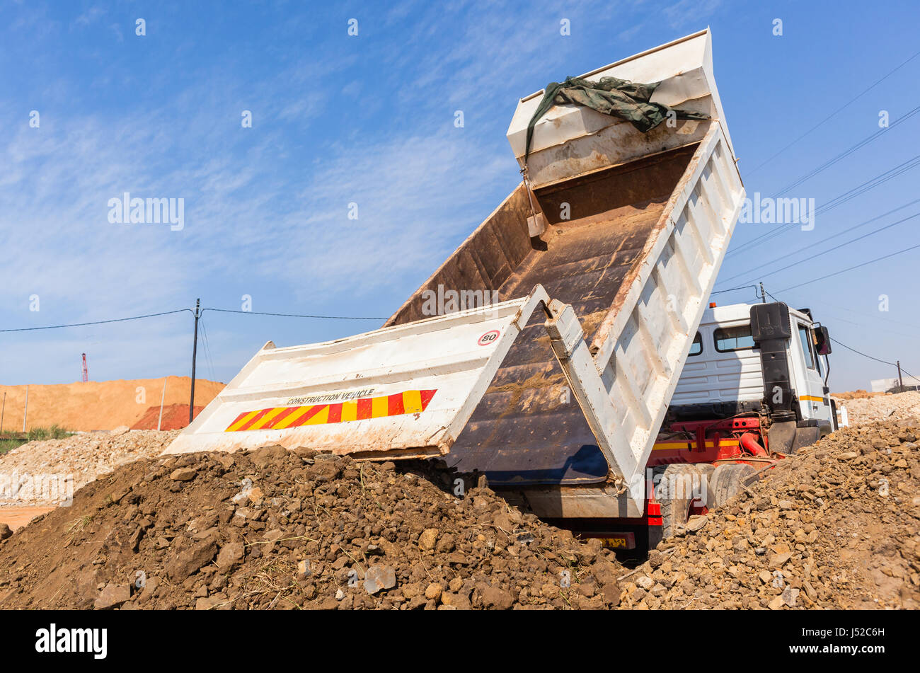 Construction Truck vehicle bucket bin tipping offloading earth closeup ...