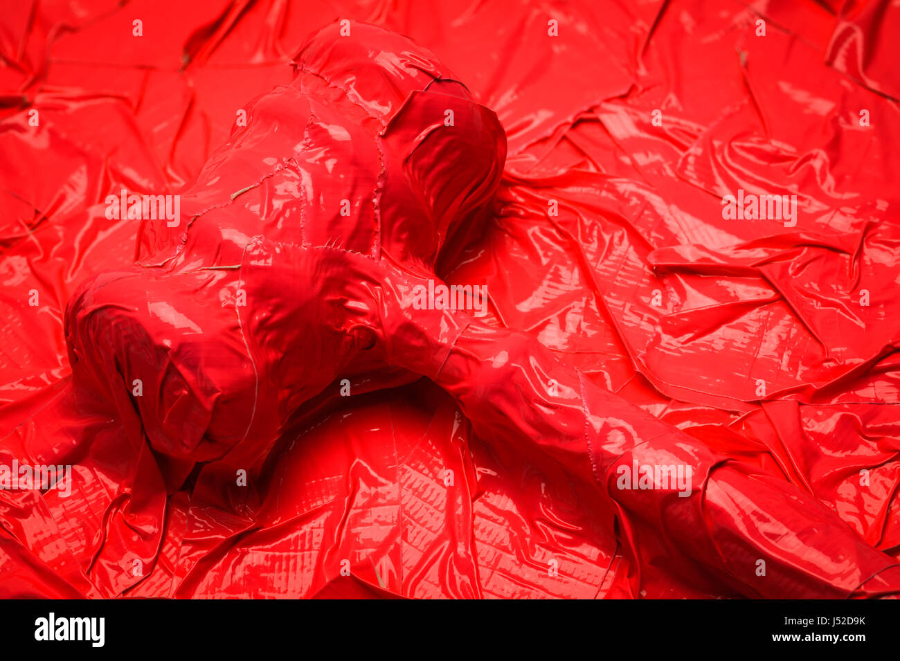 Judge Gavel Completely Covered In Red Tape Close Up. Stock Photo