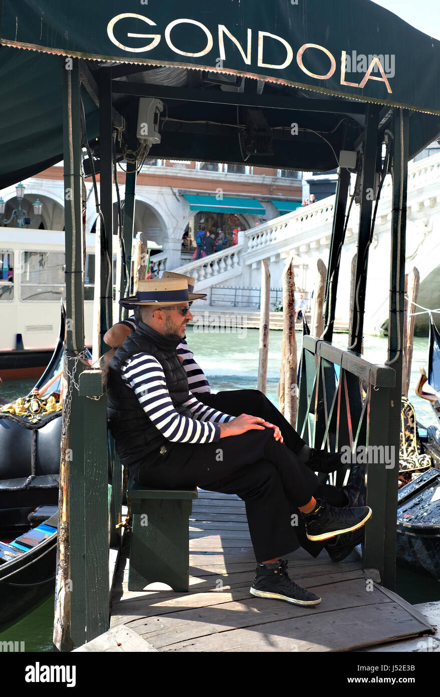 Gondoliers by the Rialto Bridge, Venice, Italy. Stock Photo