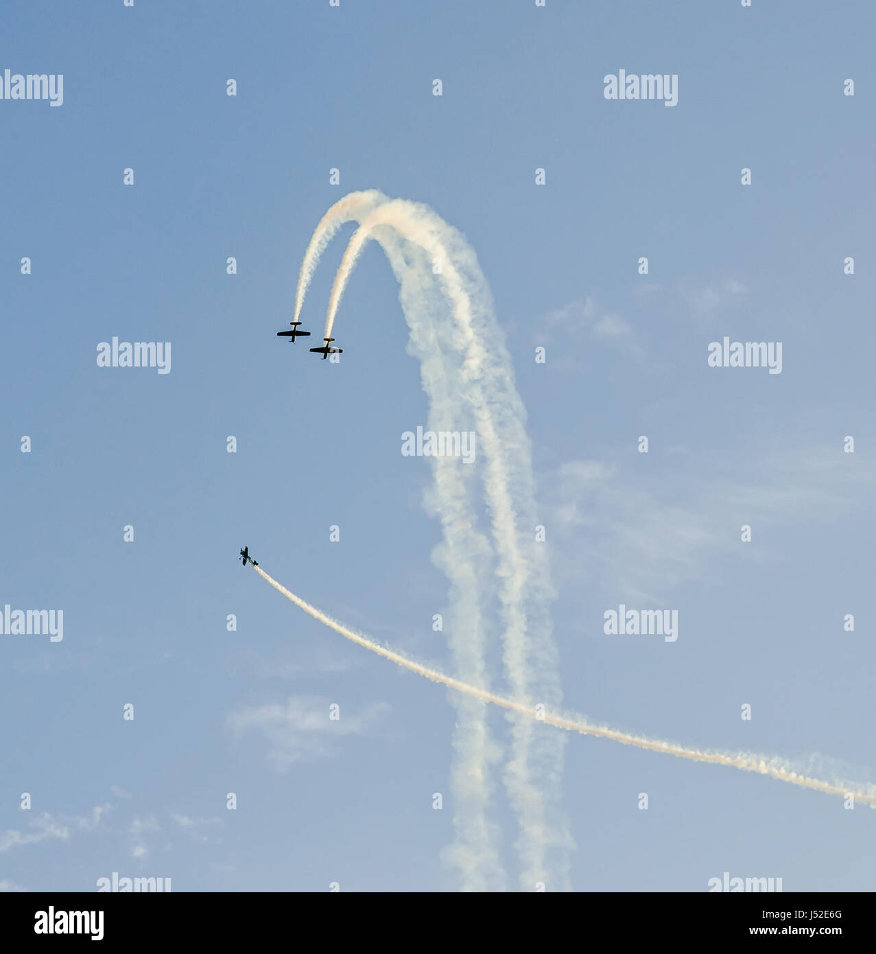 Aerobatic pilots with her colored airplanes training in the blue sky