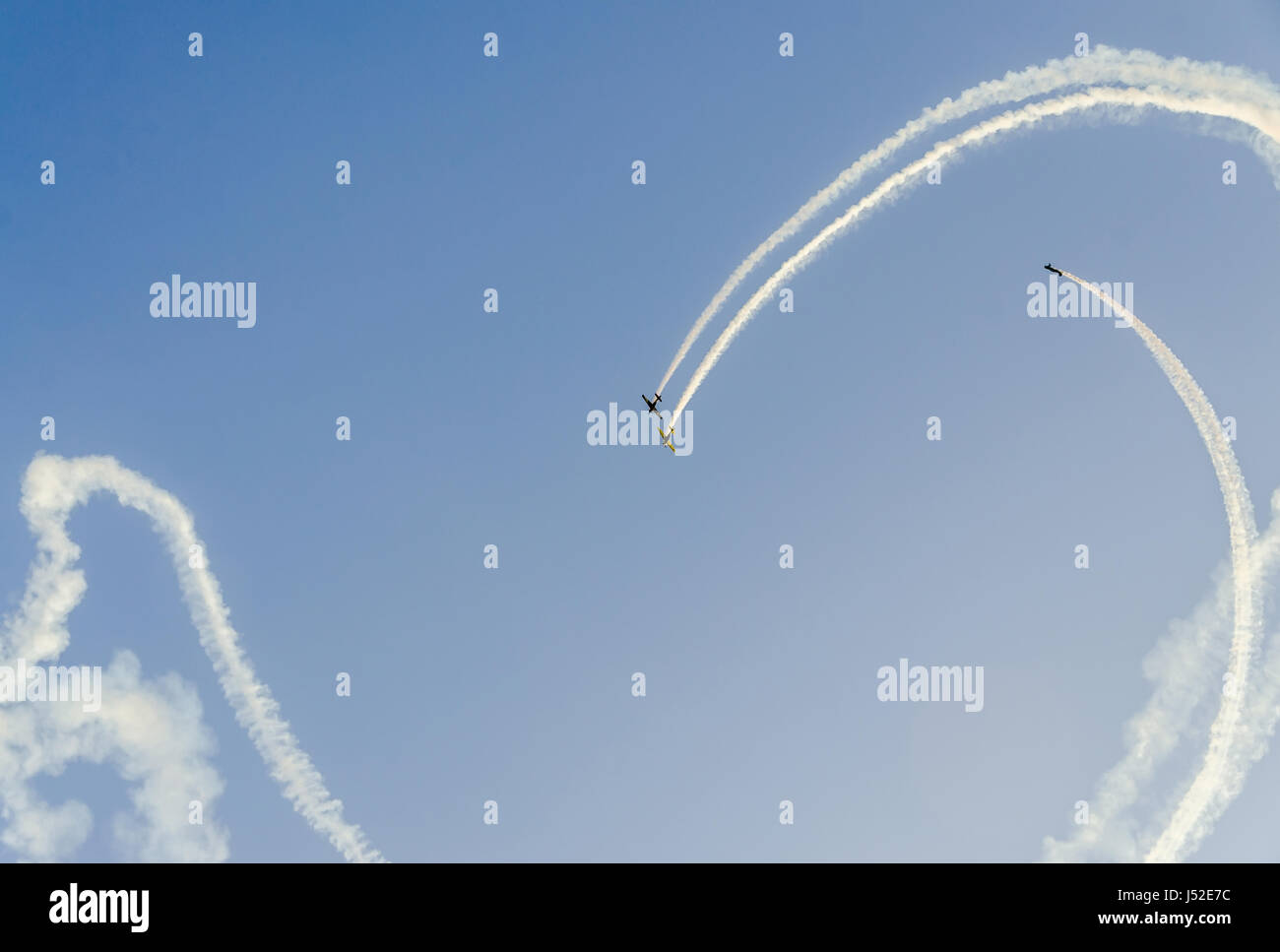 Aerobatic pilots with her colored airplanes training in the blue sky