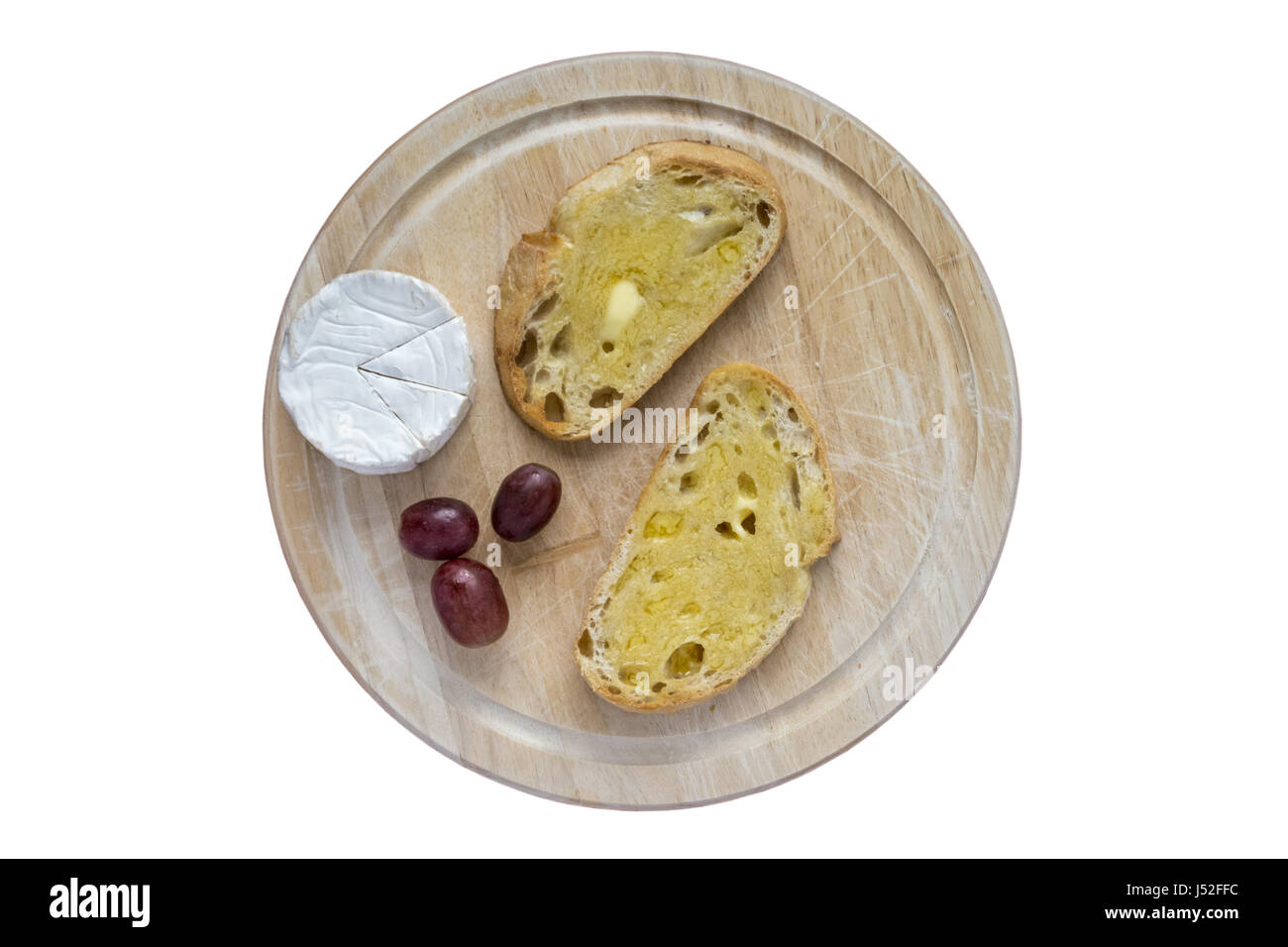 Toasted Sourdough slices and Goats Cheese on a bread board Stock Photo