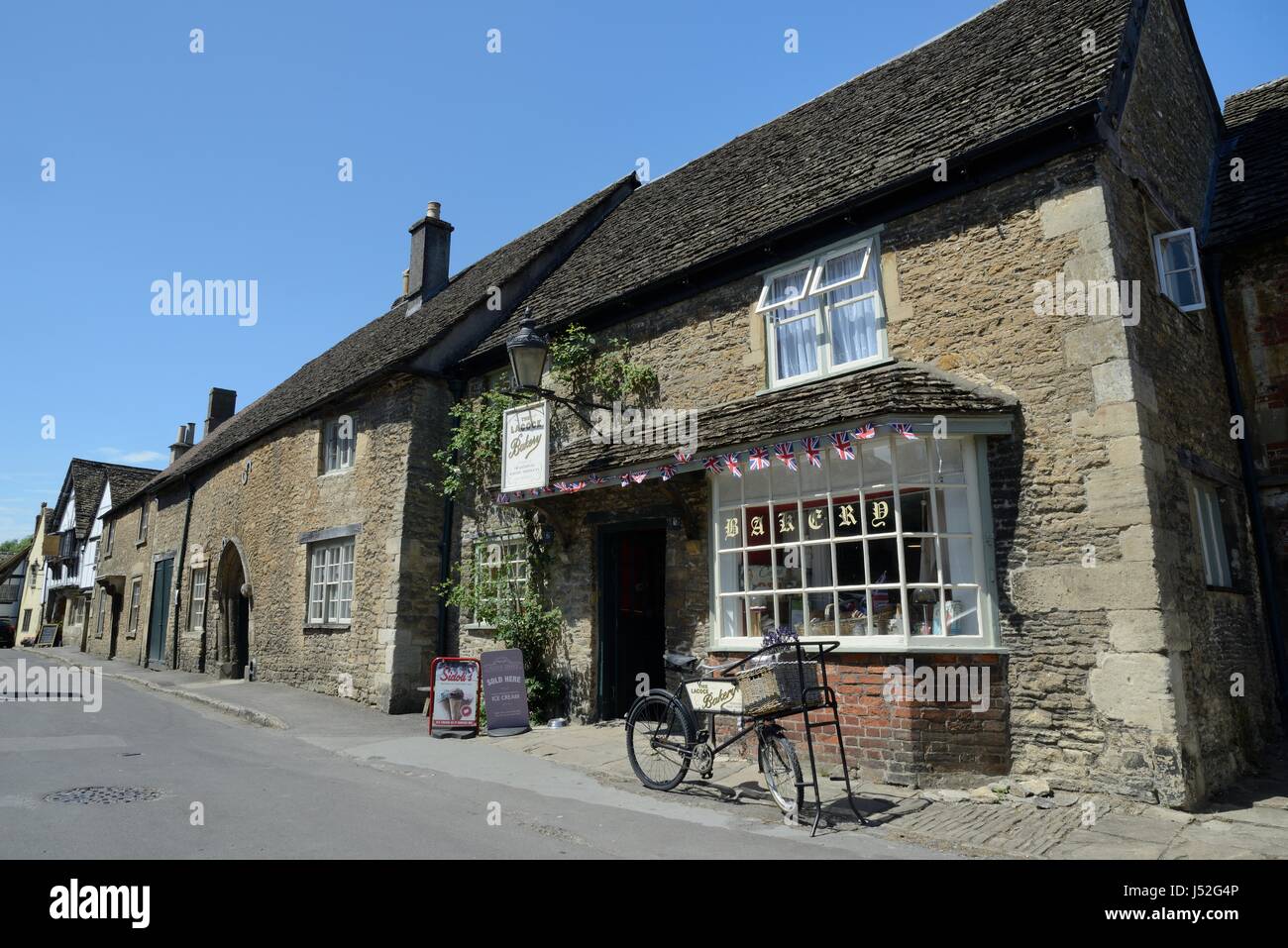 Lacock village bakery and Church street, Wiltshire, UK, July 2016. Stock Photo