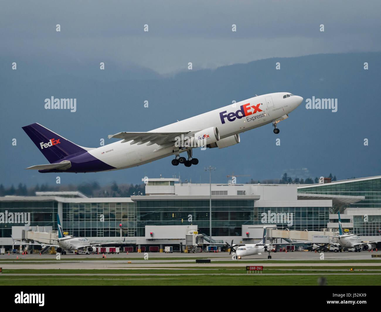 FedEx Express cargo airline plane airplane aeroplane Airbus A300-600 take taking off Vancouver International Airport airborne Stock Photo