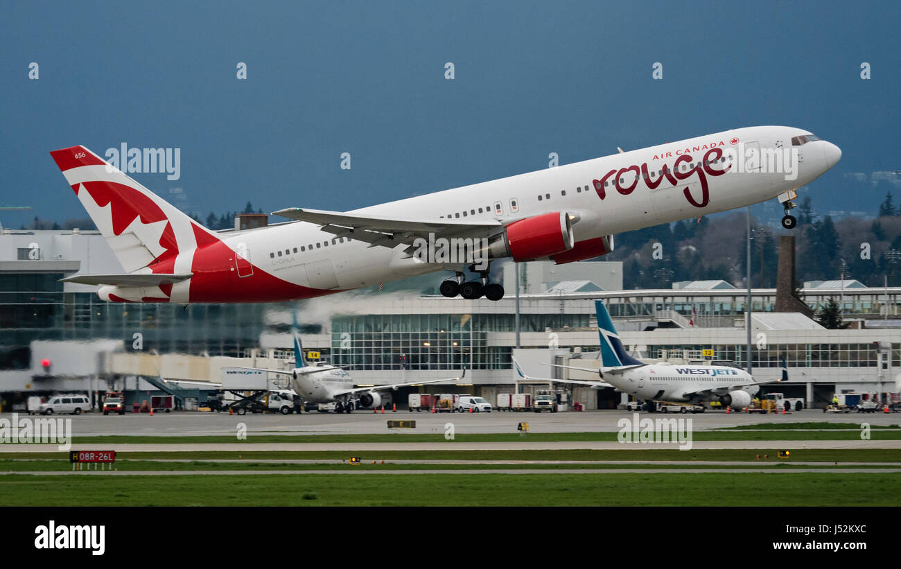Air Canada Rouge plane airplane aeroplane Boeing 767 (767-300ER) wide-body jetliner take taking off Vancouver International Airport Westjet planes at  Stock Photo