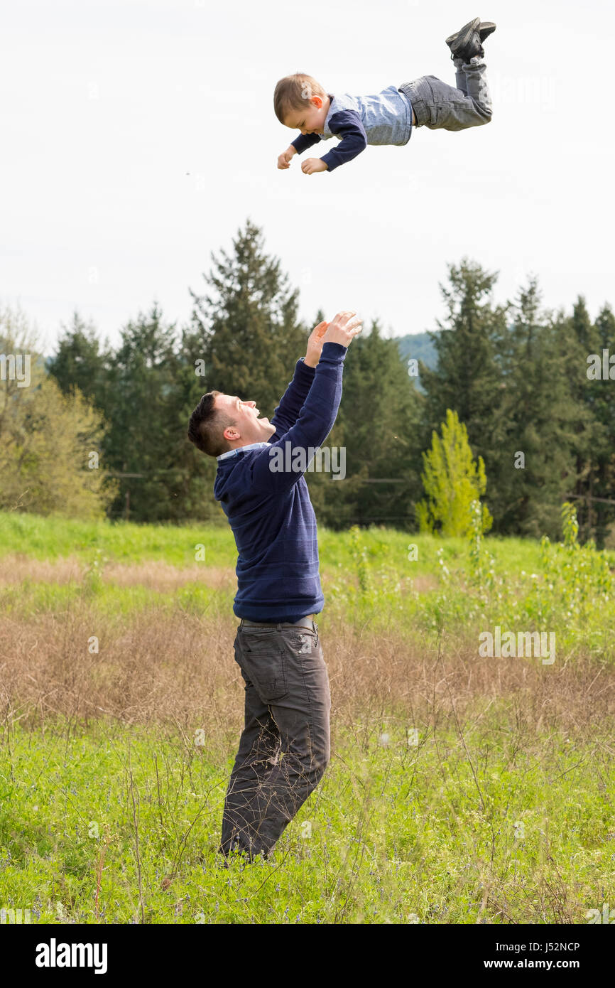 Father Throwing Son in Air Stock Photo Alamy