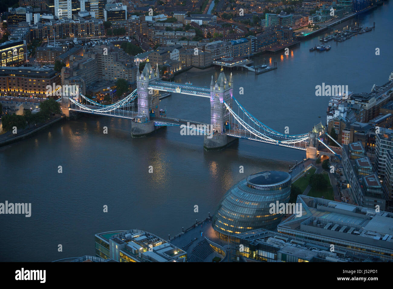 Aerial view of London at night. The river Thames, Tower Bridge and urban buildings in view. Stock Photo