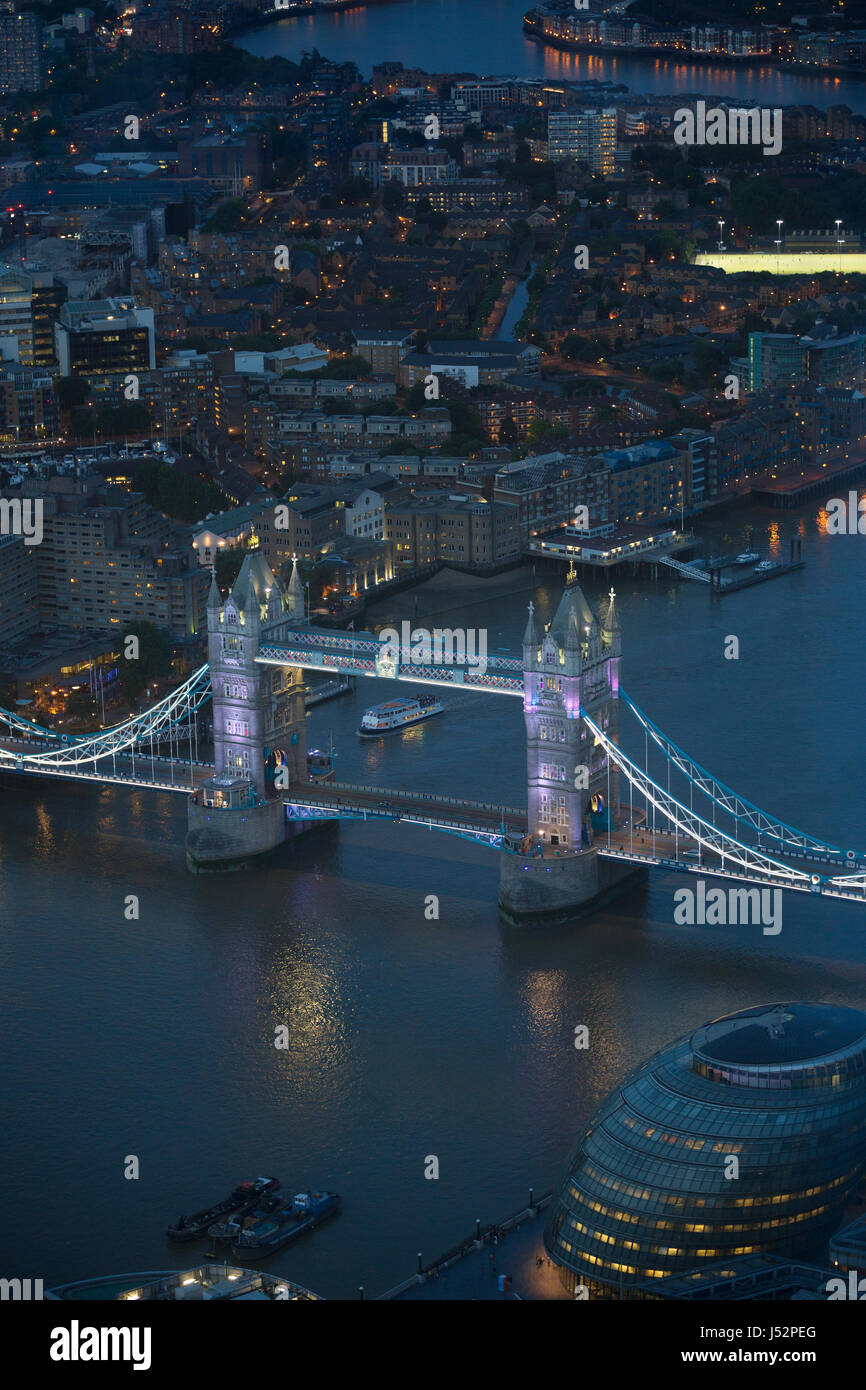 Aerial view of London at night. The river Thames, Tower Bridge and urban buildings in view. Stock Photo
