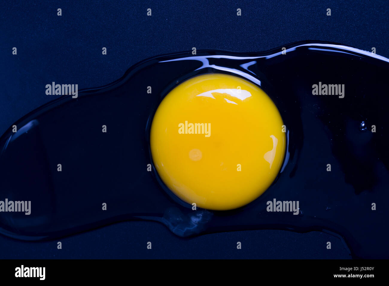 The broken egg on black background Stock Photo - Alamy