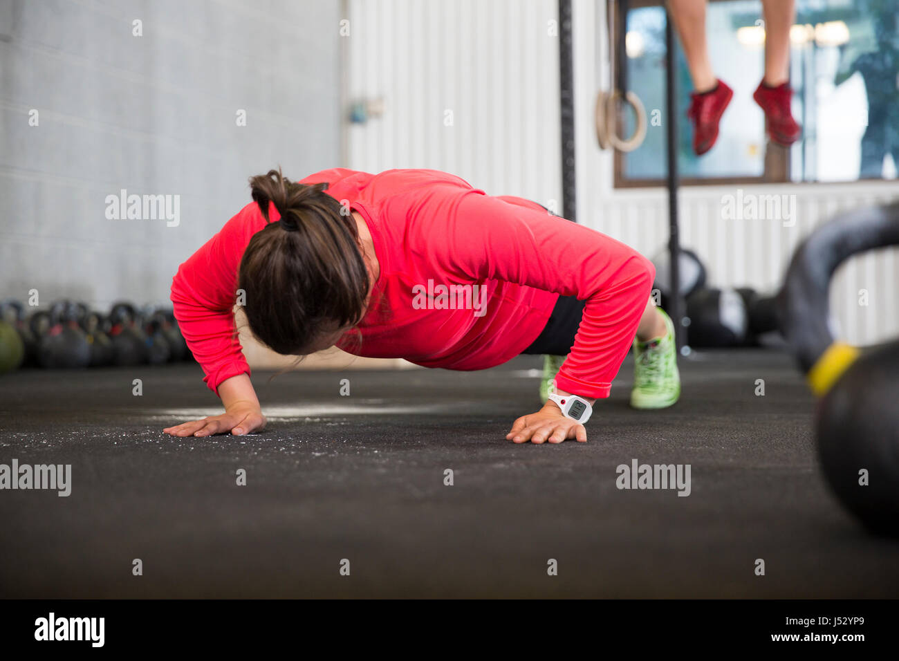 Fit Female Athlete Doing Pushups In Health Club Stock Photo