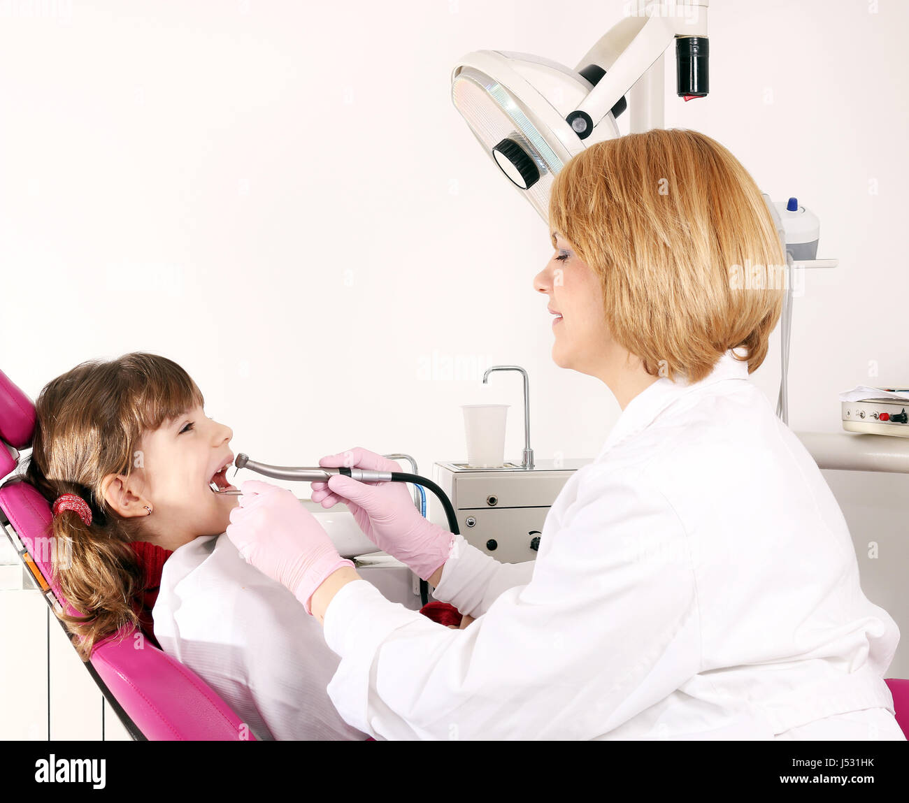 little girl and dentist drilling treatment Stock Photo Alamy