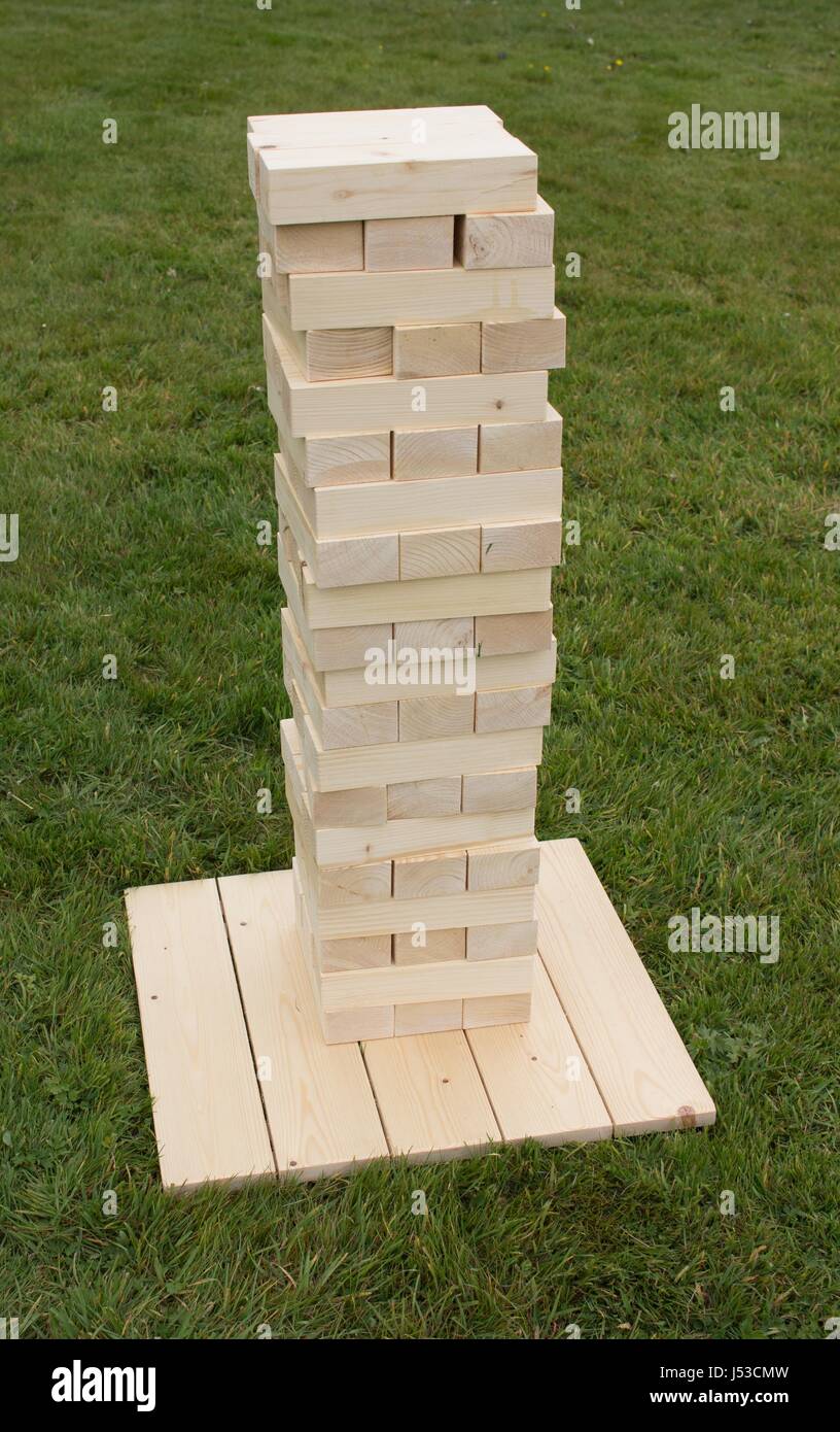 Young Man Play Giant Jenga Game Outdoors Using A Ladder Stock Photo -  Download Image Now - iStock