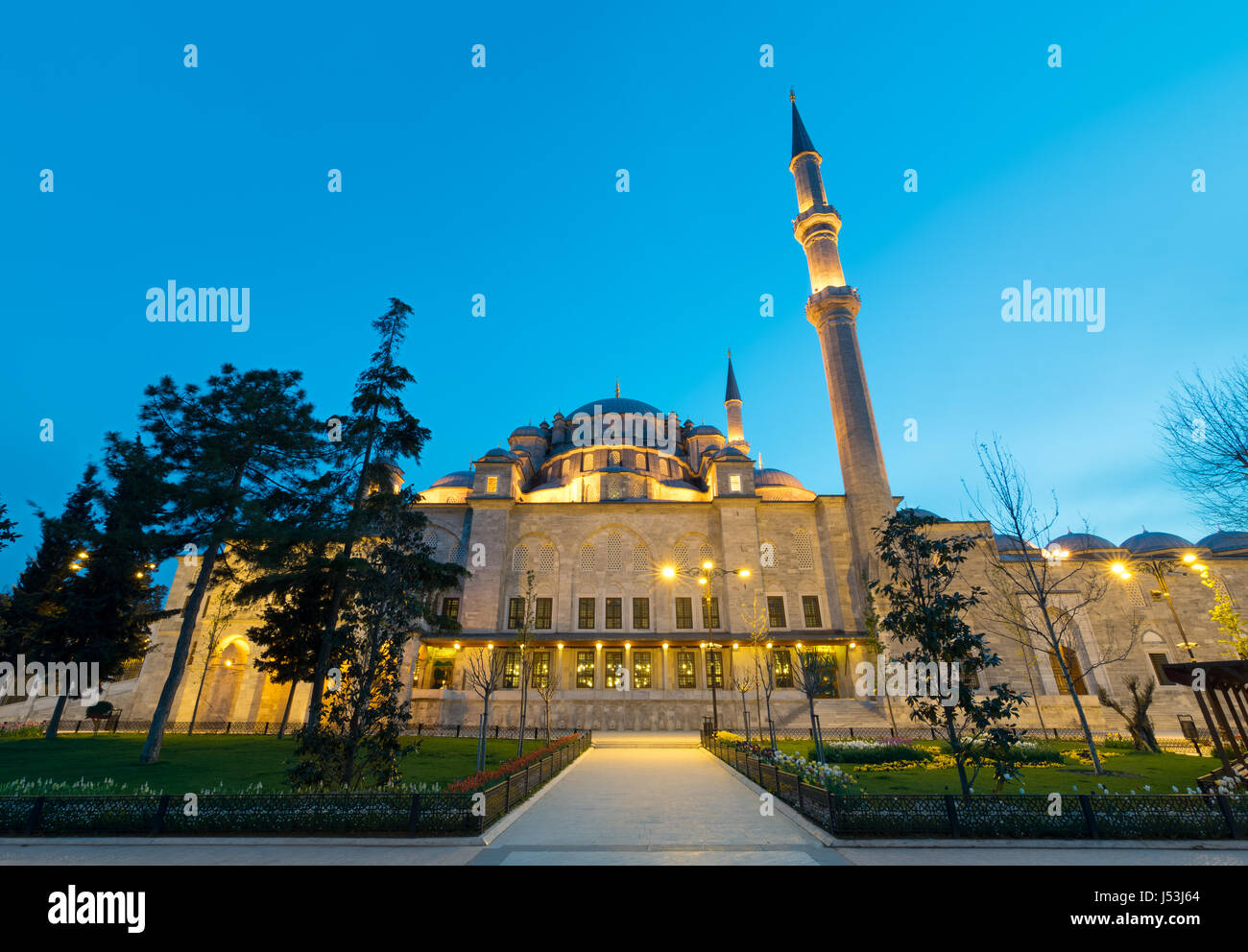 Exterior low angle night shot of Fatih Mosque, an Ottoman imperial mosque located on the Third Hill of Istanbul, Turkey Stock Photo