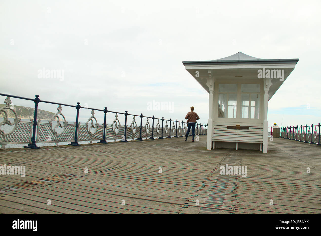 Swanage, UK -  12 May: A tourist seen on the Swanage Pier. General view of ​the seaside town of ​ Swanage​ in Dorset, England.​  © David Mbiyu/Alamy Live News Stock Photo