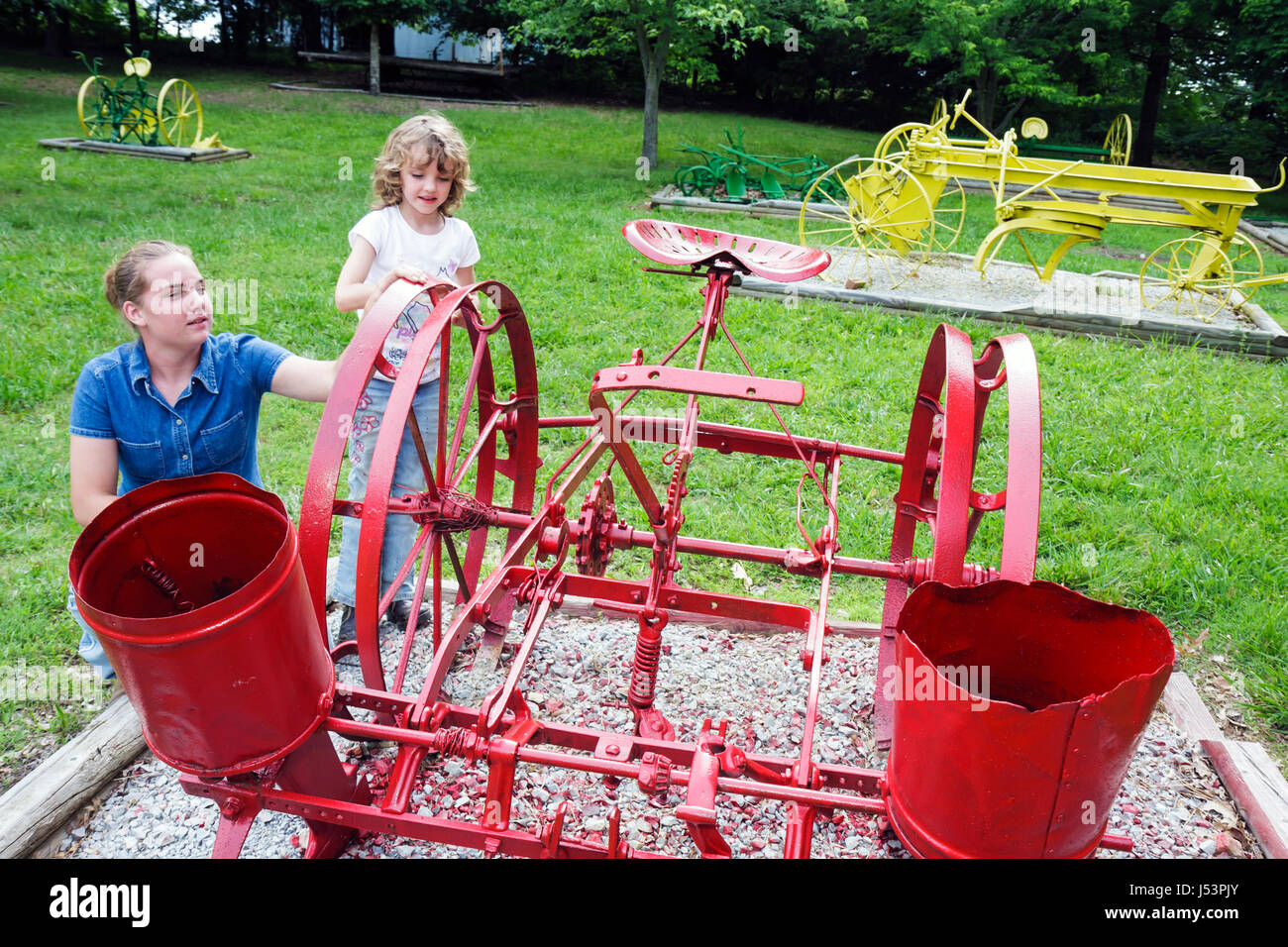 Arkansas Maynard,Maynard Pioneer Museum and Park,antique farm equipment,regional heritage,girl girls,youngster youngsters youth youths female kid kids Stock Photo