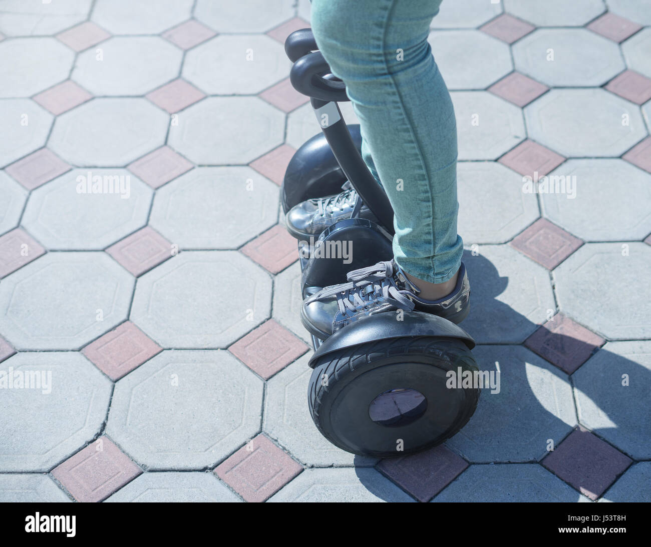 woman legs ride gyroscooter or hoverboard Stock Photo