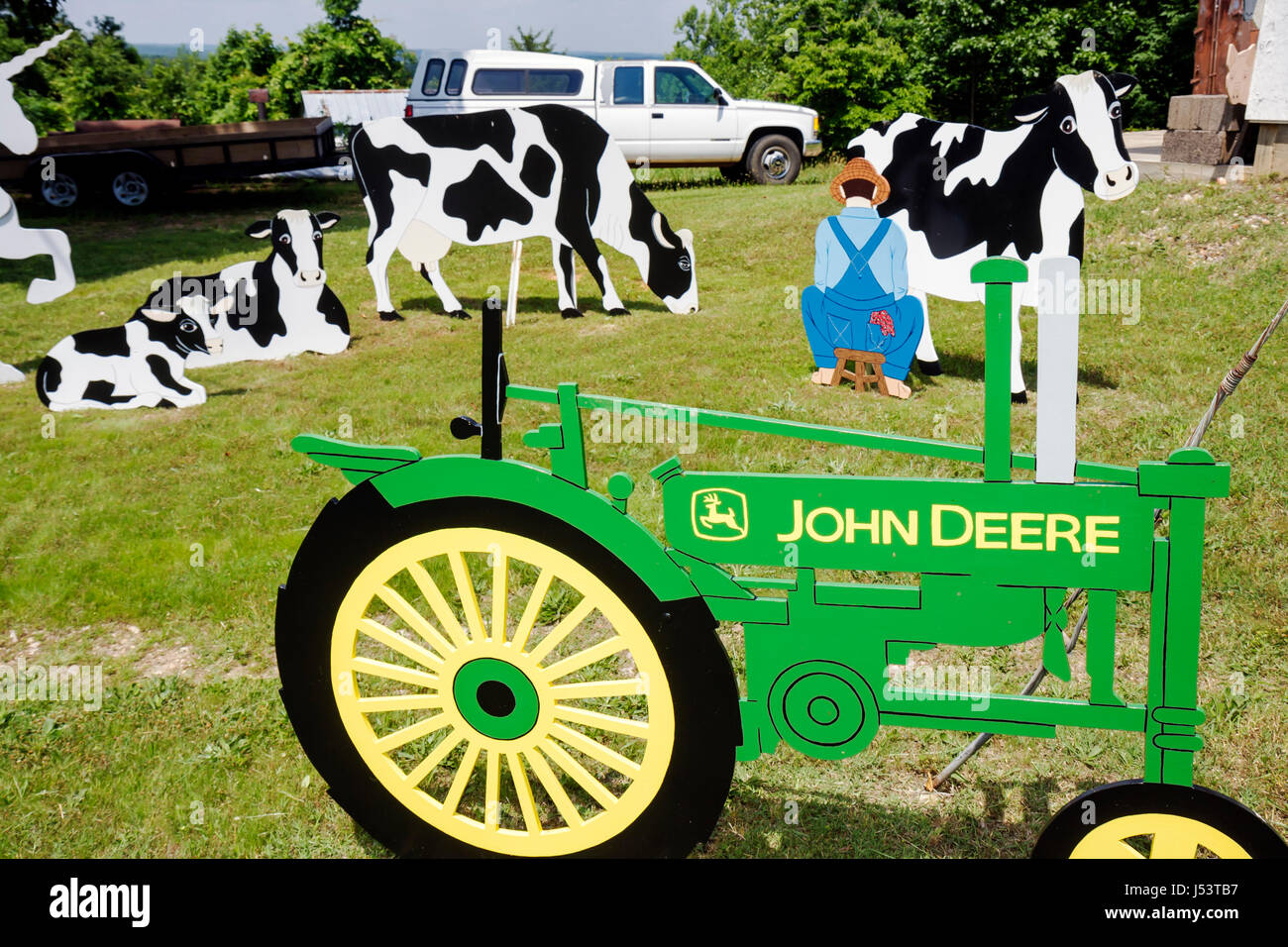 Arkansas Ozark Mountains,Williford,E and L Cypress Clocks,handcraft,woodwork,cutouts,John Deere tractor,farmer milking cow,painted,art artwork,artist, Stock Photo