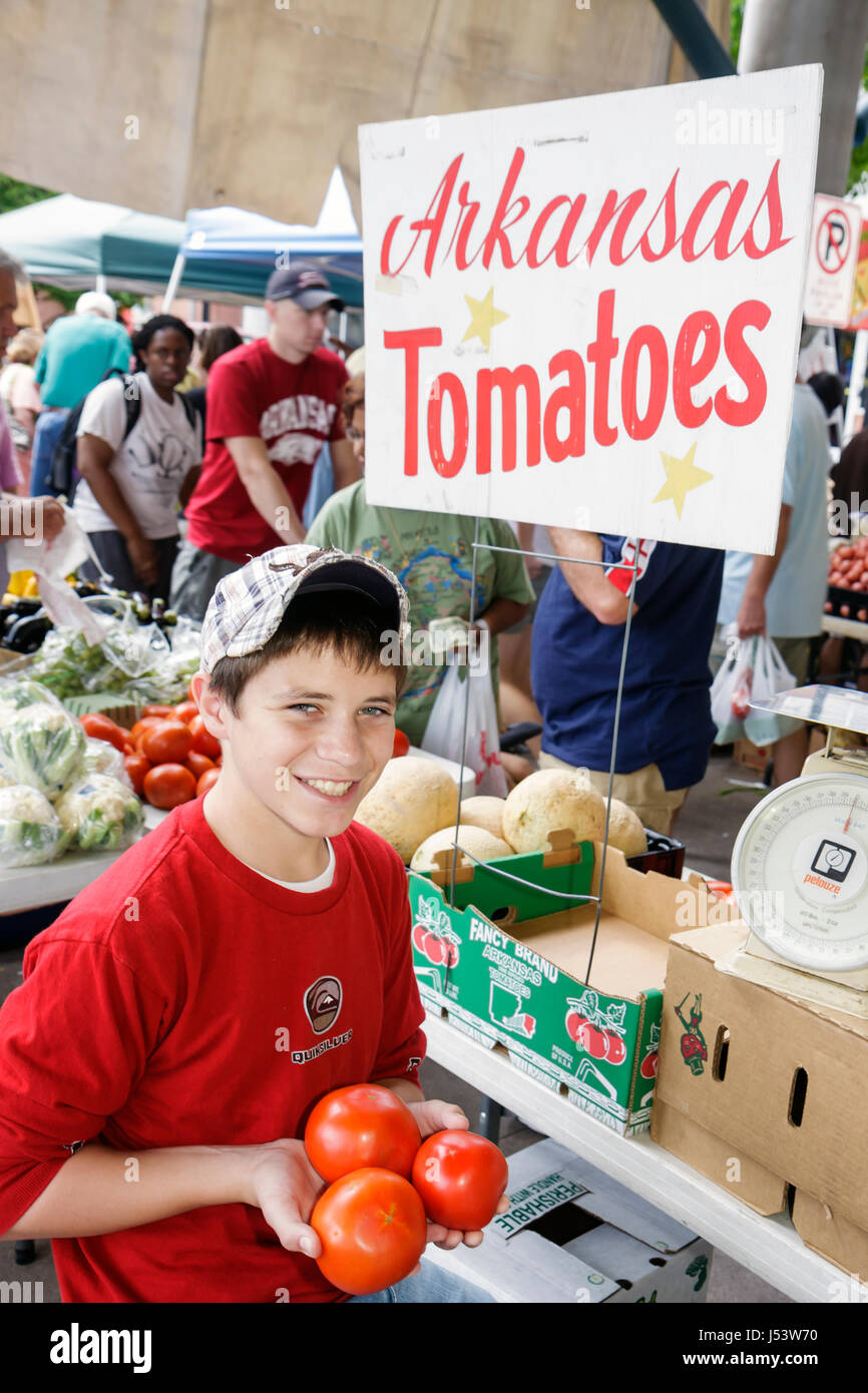 Little Rock Arkansas,River Market,farmers market,locally grown produce,buyers,sellers,boy boys,male kid kids child children youngster,red tomatoes,tom Stock Photo