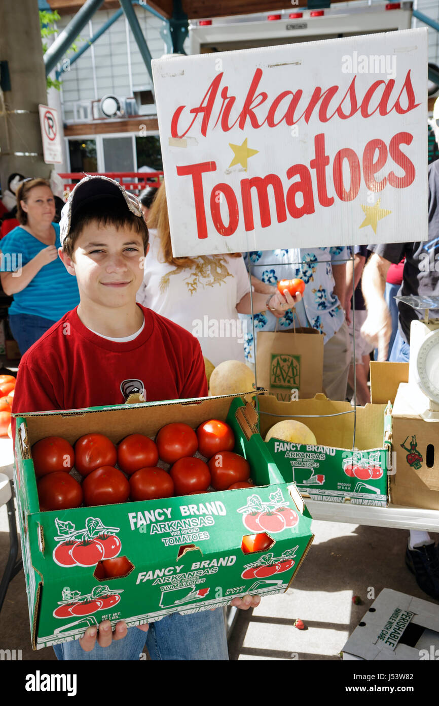 Little Rock Arkansas,River Market,farmers market,buyers,sellers,locally grown produce,boy boys,male kid kids child children youngster,red tomatoes,tom Stock Photo