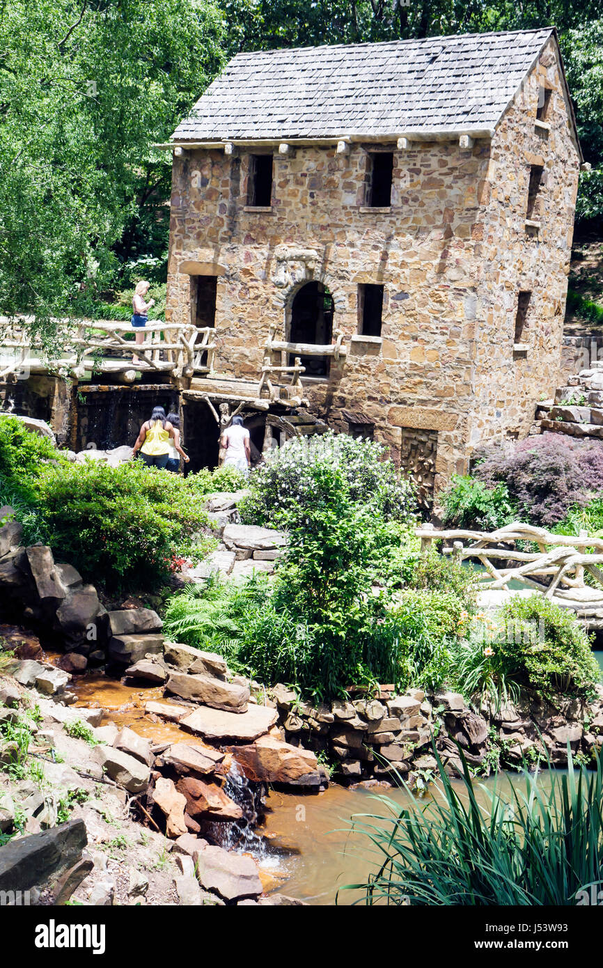 Little Rock Arkansas,T.R. Pugh Memorial Park,The Old Mill,appeared in Gone With The Wind,women,men,bridge,stone building,gristmill replica,water power Stock Photo