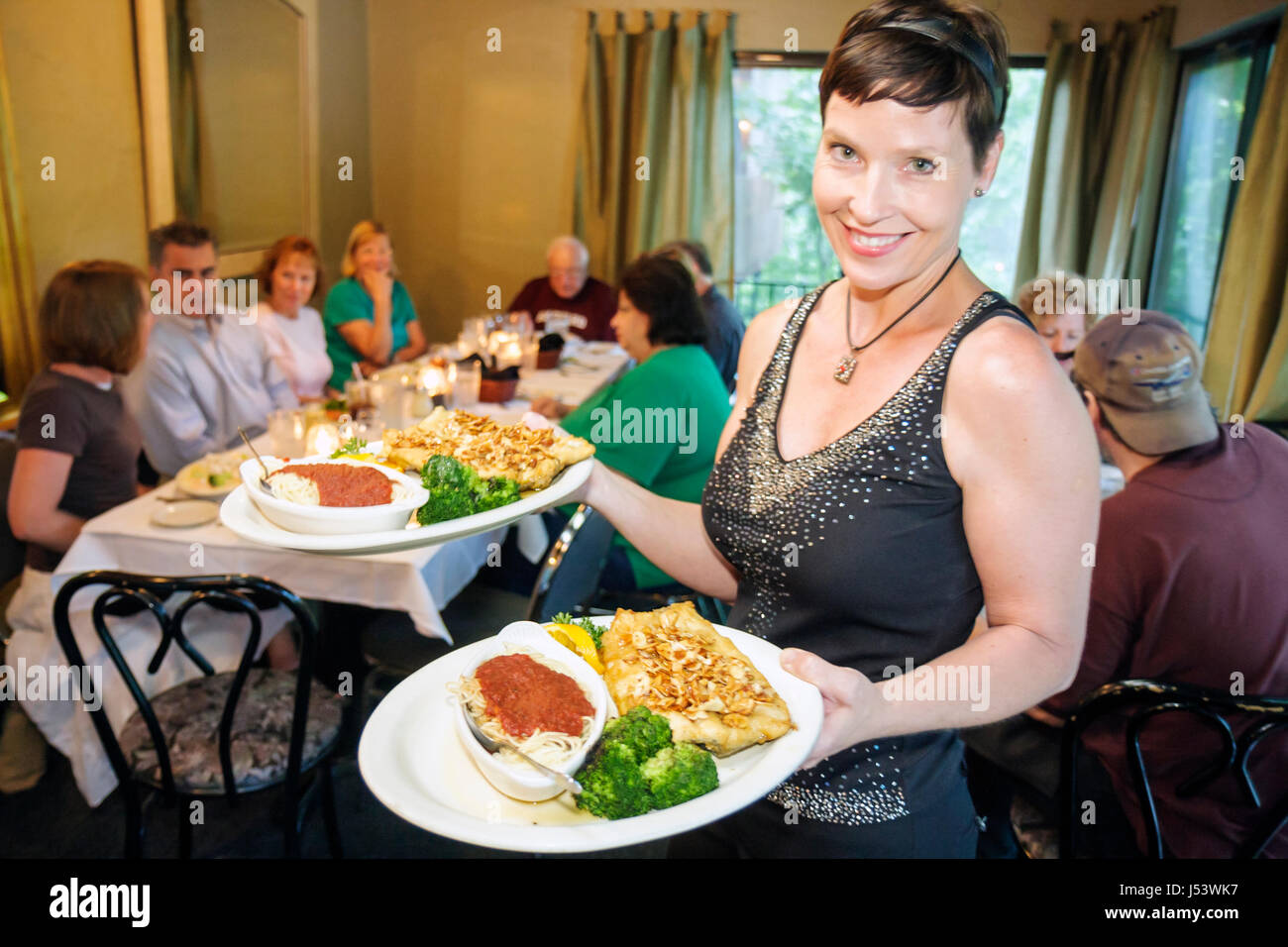 Eureka Springs Arkansas,Ozark Mountains,Devito's restaurant,food,dine,eat out,service,Italian dining,woman female women,waitress server employee interi Stock Photo
