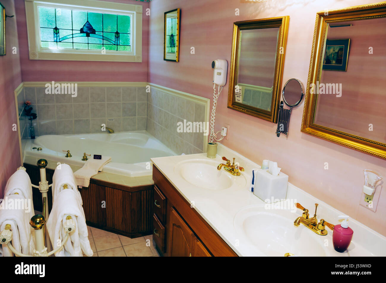 Eureka Springs Arkansas,Ozark Mountains,Arsenic & Old Lace Bed & Breakfast Inn,bathroom,sink,tub,double,his & hers,pink,Jacuzzi,AR080610018 Stock Photo