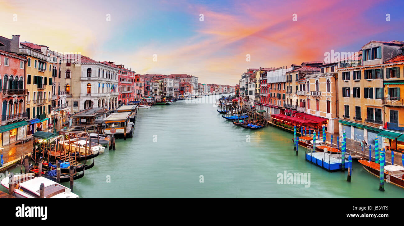 Venice Grand Canal gondolas, hotels and restaurants at sunset from the Rialto Bridge Stock Photo