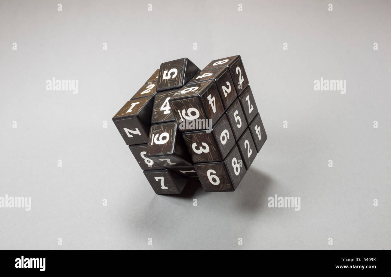 Cube with movable parts having on each side printed numbers than can be scrambled , image about data security and cryptography Stock Photo