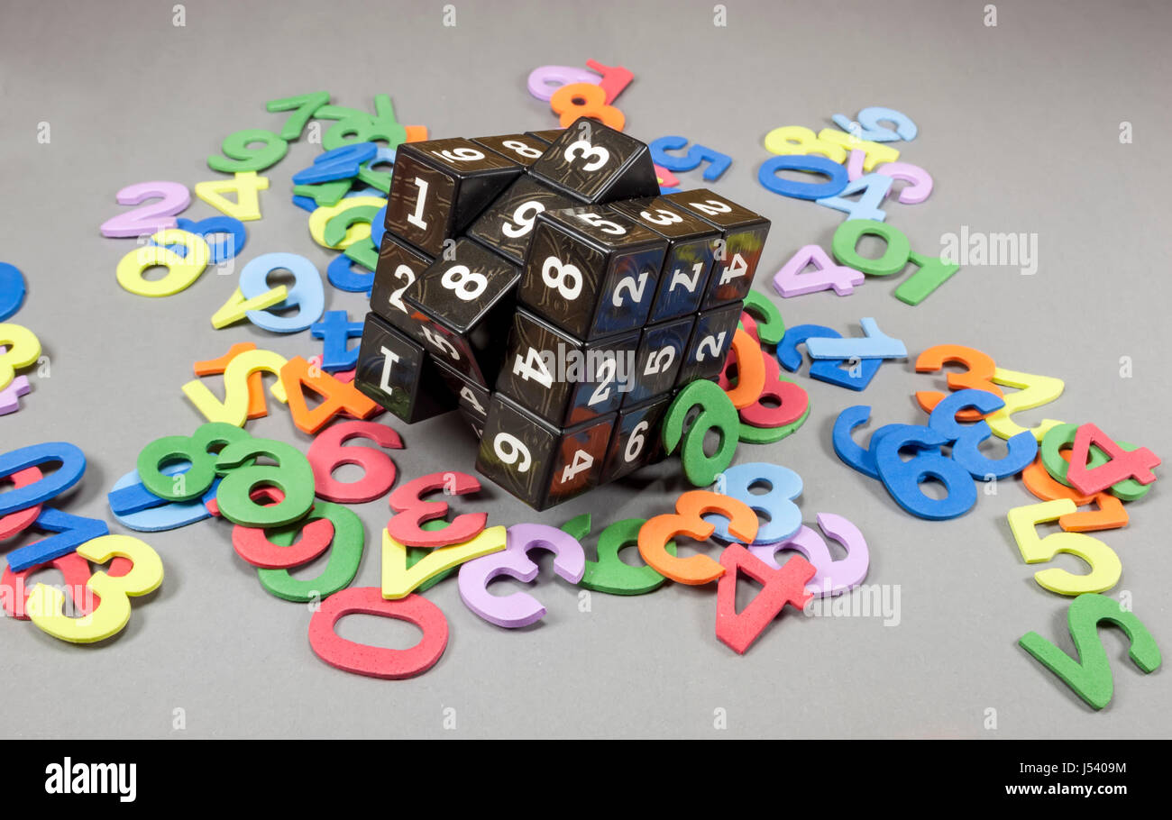 Cube with movable parts having on each side printed numbers with colored numbers around, concept about computer security and cryptography Stock Photo