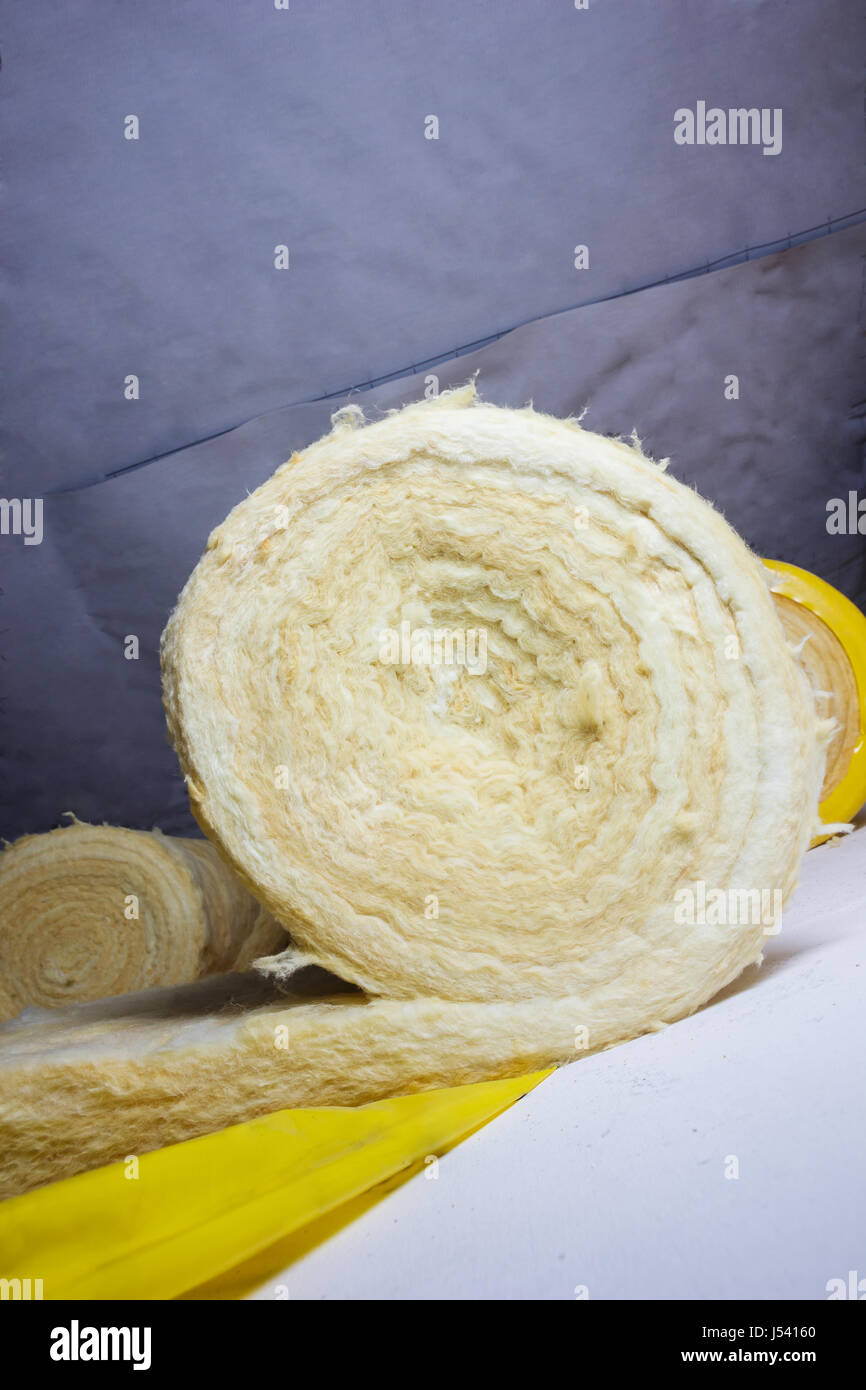 thermal insulation role in yellow package at attic background Stock