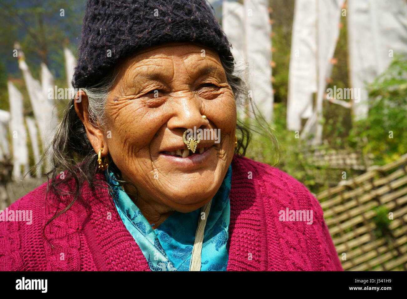 Older women of the Grurung tribe withtrraditional jewelery, a golden ring in nose and earrings. Yuksom, Sikkim, India Stock Photo