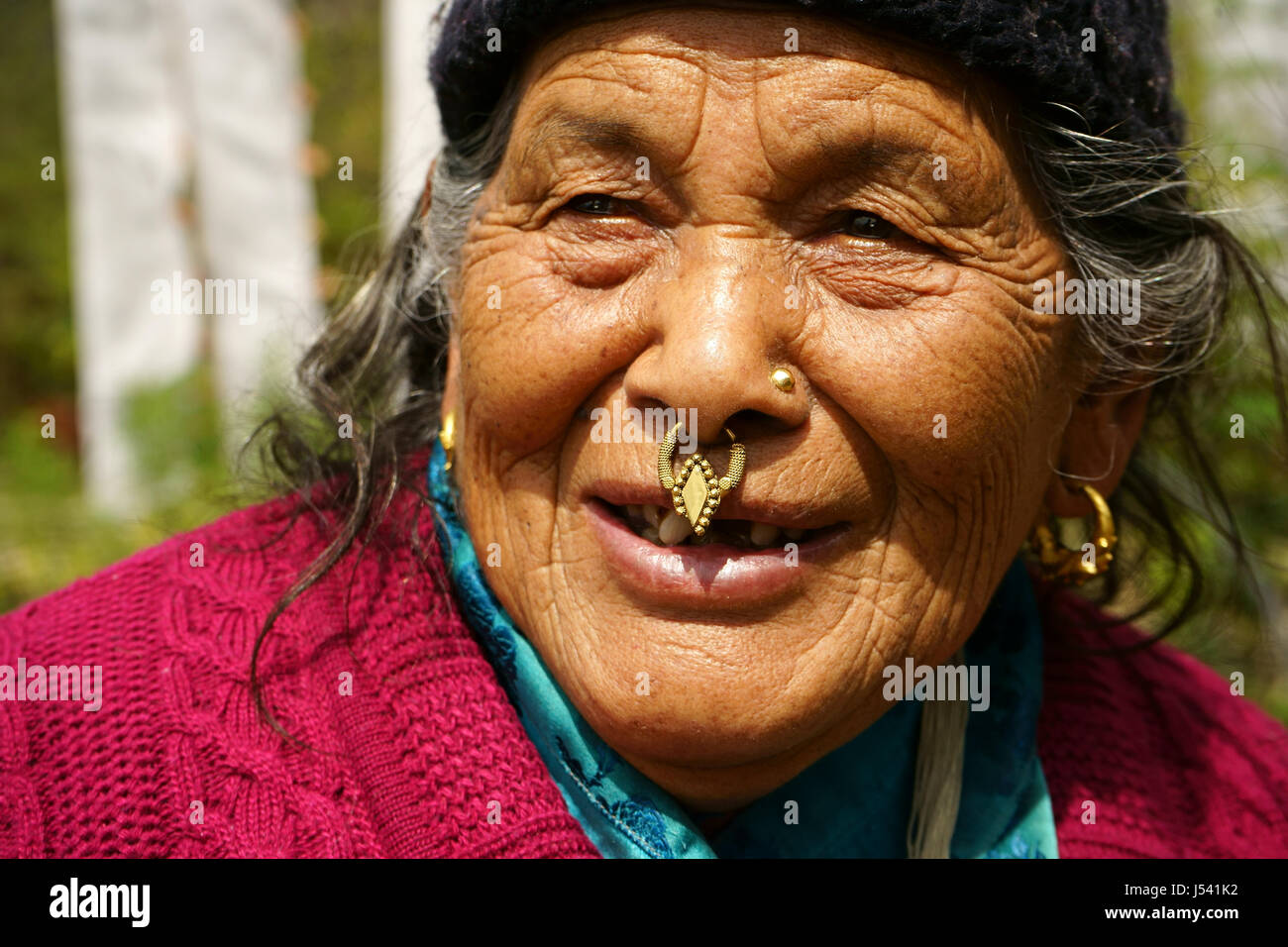 Older women of the Grurung tribe with traditional jewelery, a golden ring in nose and earrings. Yuksom, Sikkim, India Stock Photo