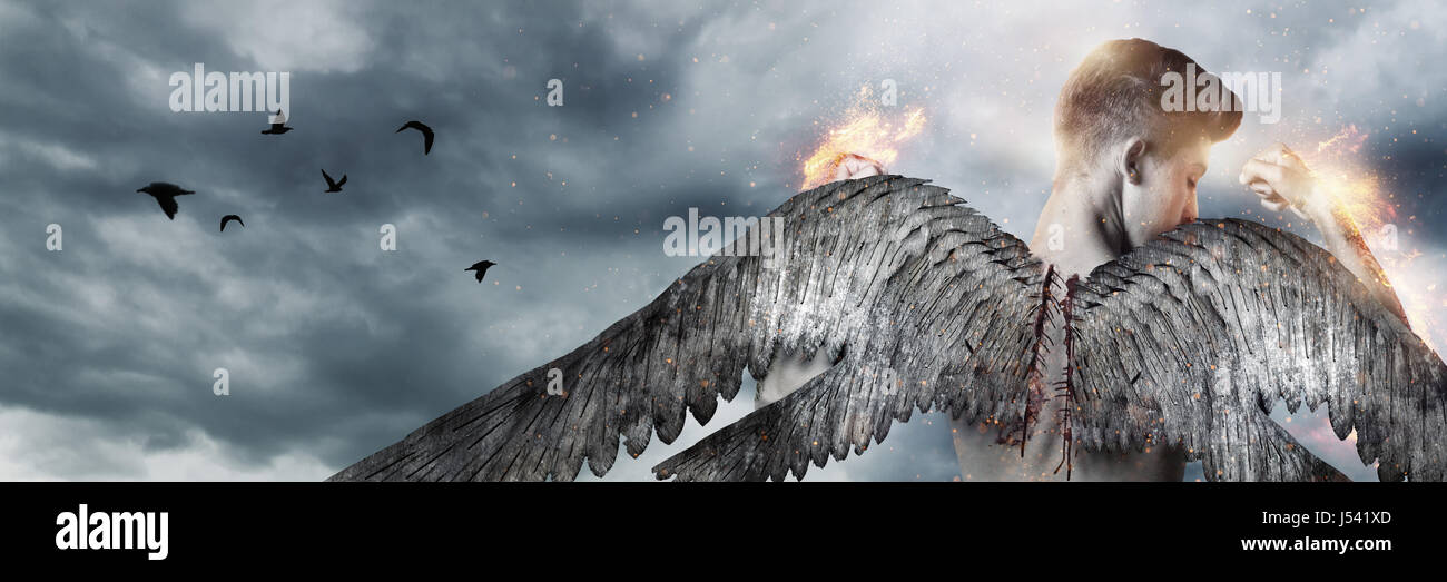 back of strong angel with wings in fire in front of grey clouds Stock ...