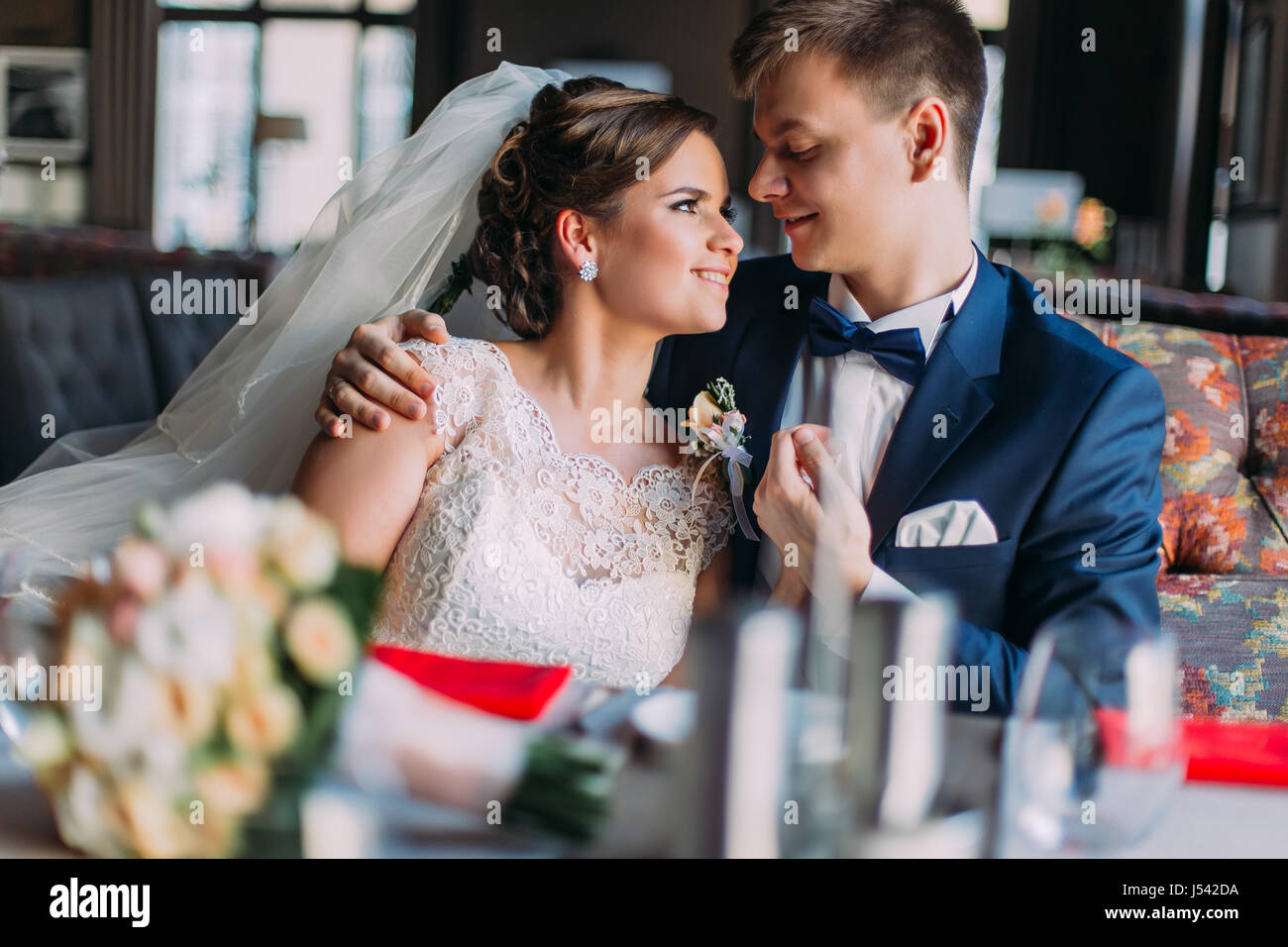 Newlywed Enloved Romantic Couple Holding Each Other While Sitting On