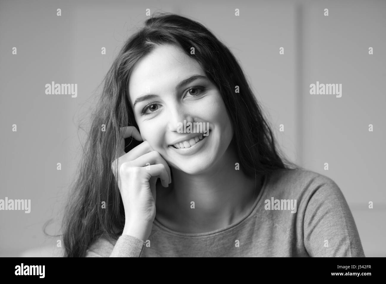 Smiling beautiful girl posing and looking at camera Stock Photo - Alamy