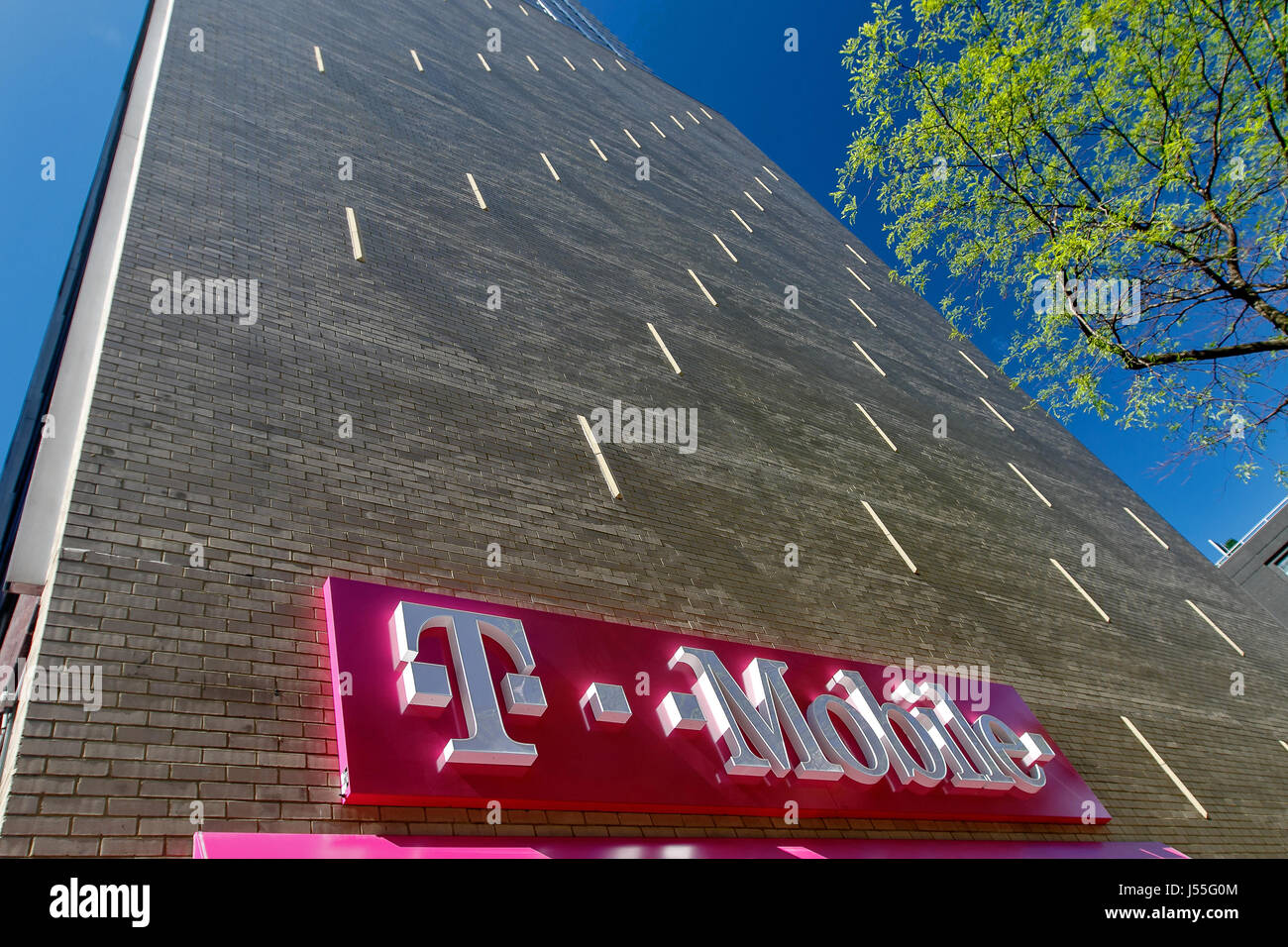 New York, May 08, 2017: Exterior sign on a wall over a T-Mobile retail store in Manhattan. Stock Photo
