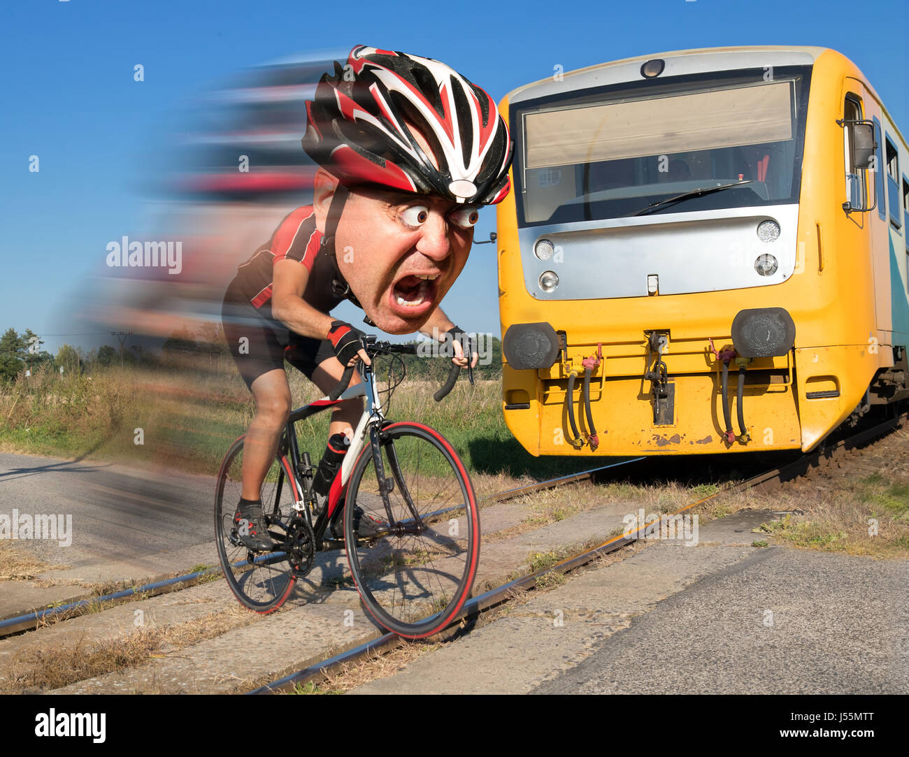 Terrified cyclist is rushing before by train on the tracks. Shocked biker ride a railway crossing in front of an approaching train. Stock Photo
