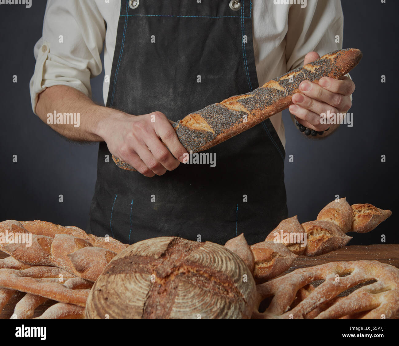 Men's hands hold a baguette Stock Photo - Alamy