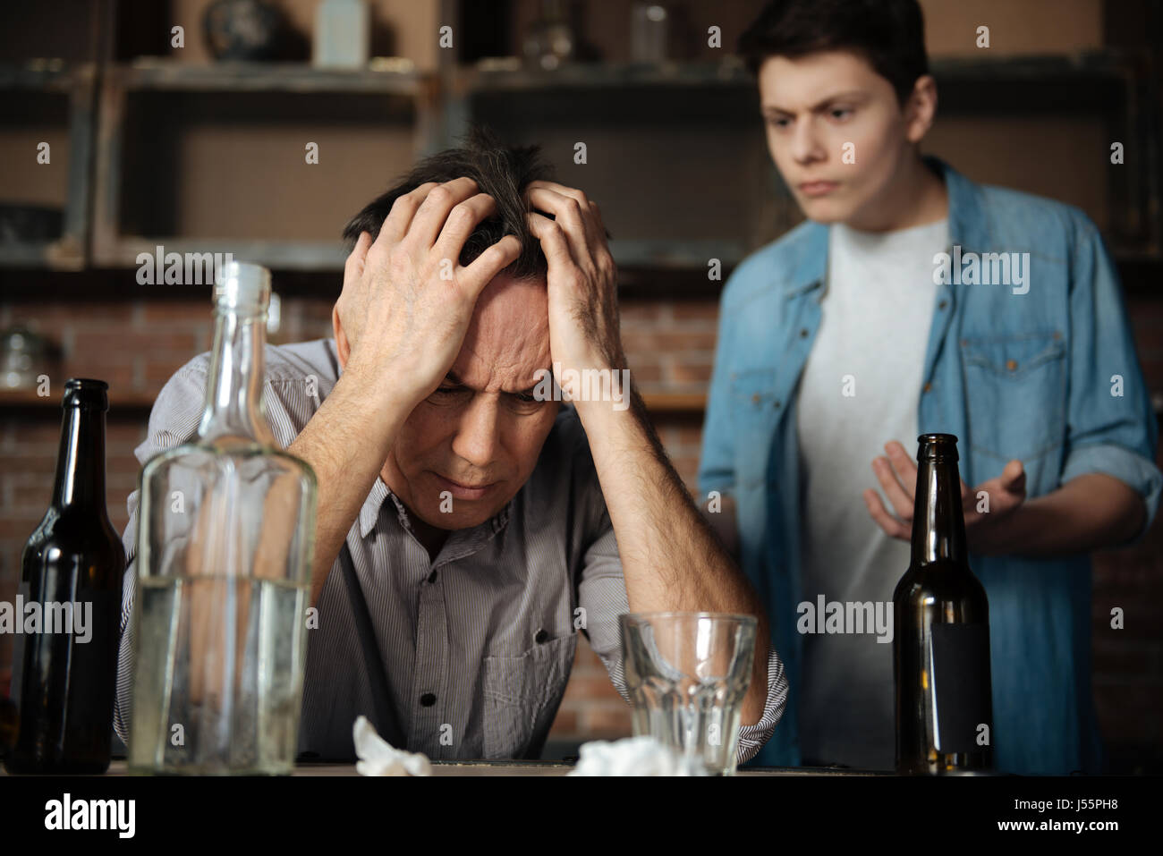 Portrait of upset man putting both hands on forehead Stock Photo - Alamy