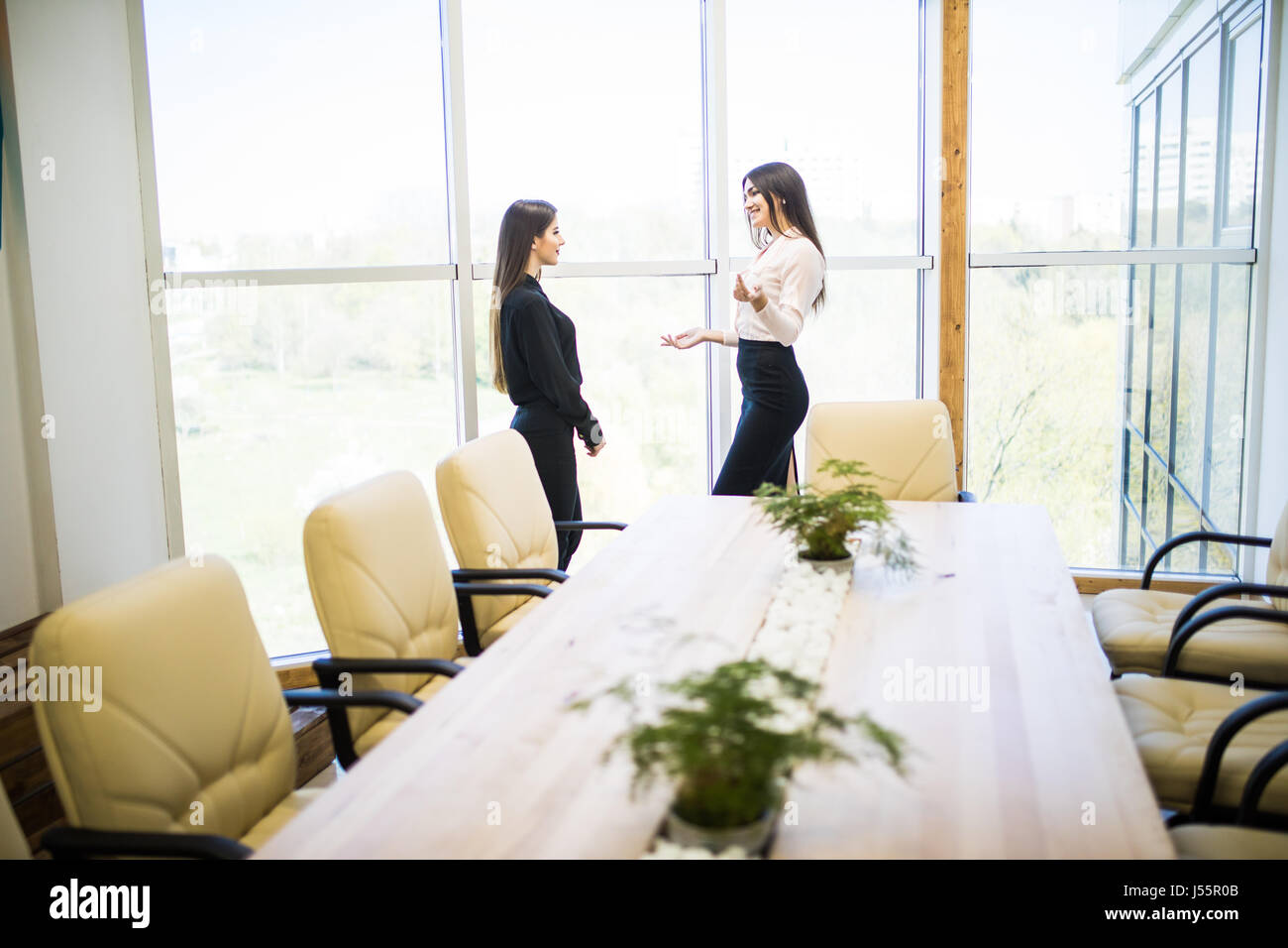 Businesswomen Having Informal Meeting In Modern Office Stock Photo - Alamy