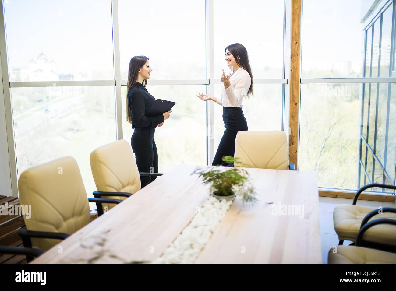 Businesswomen Having Informal Meeting In Modern Office Stock Photo - Alamy
