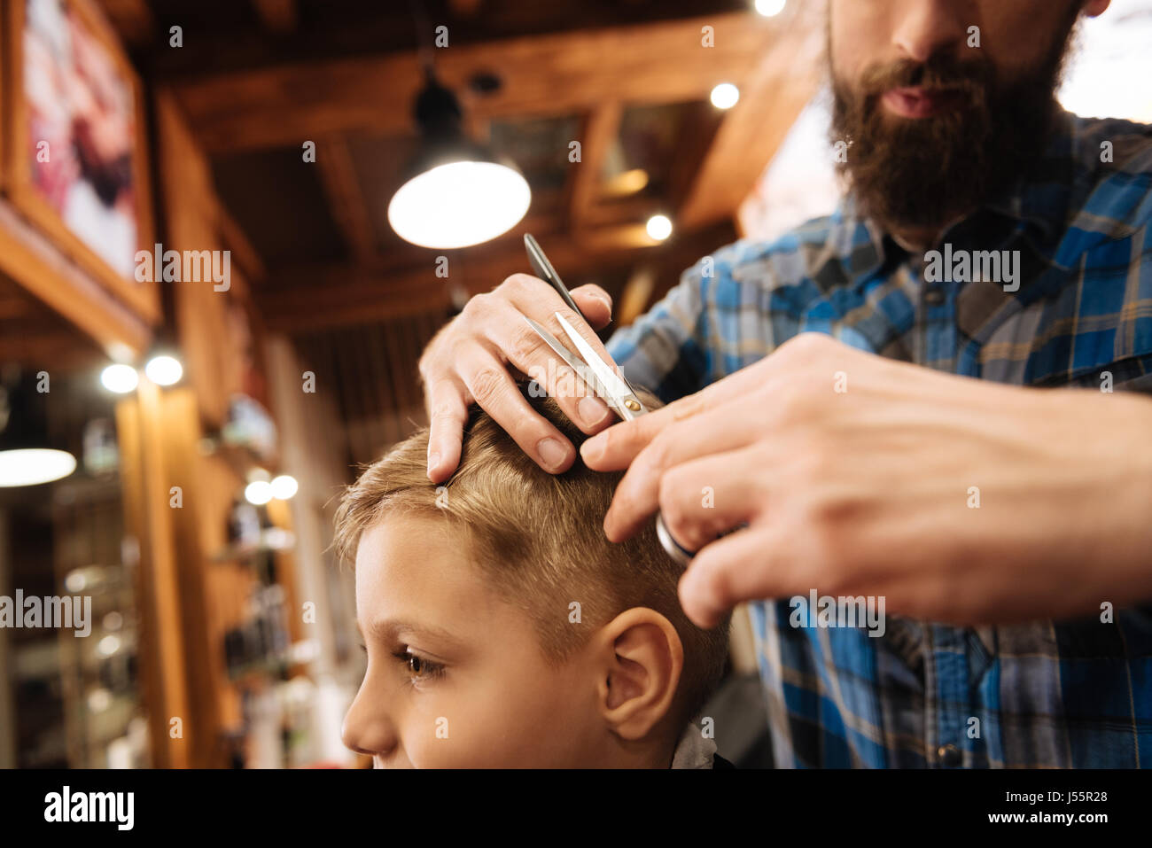 Good looking young barber using scissors Stock Photo Alamy