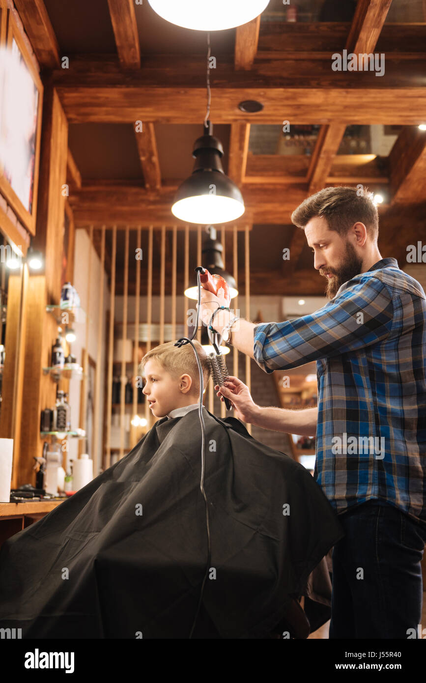 Nice experienced hairdresser working with a hair dryer Stock Photo Alamy