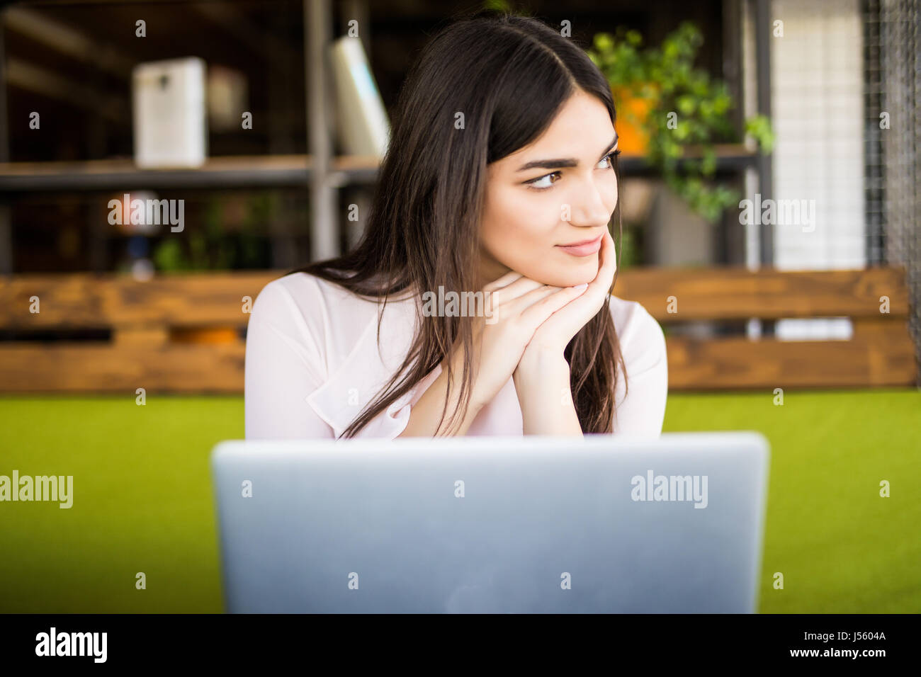 pretty young businesswoman using computer in office Stock Photo - Alamy