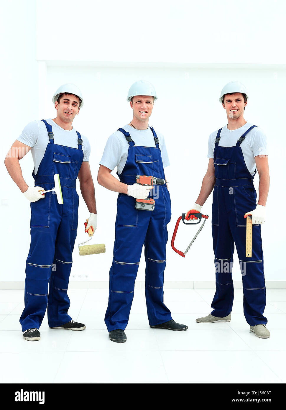 Group of professional industrial workers. Isolated over white background. Stock Photo