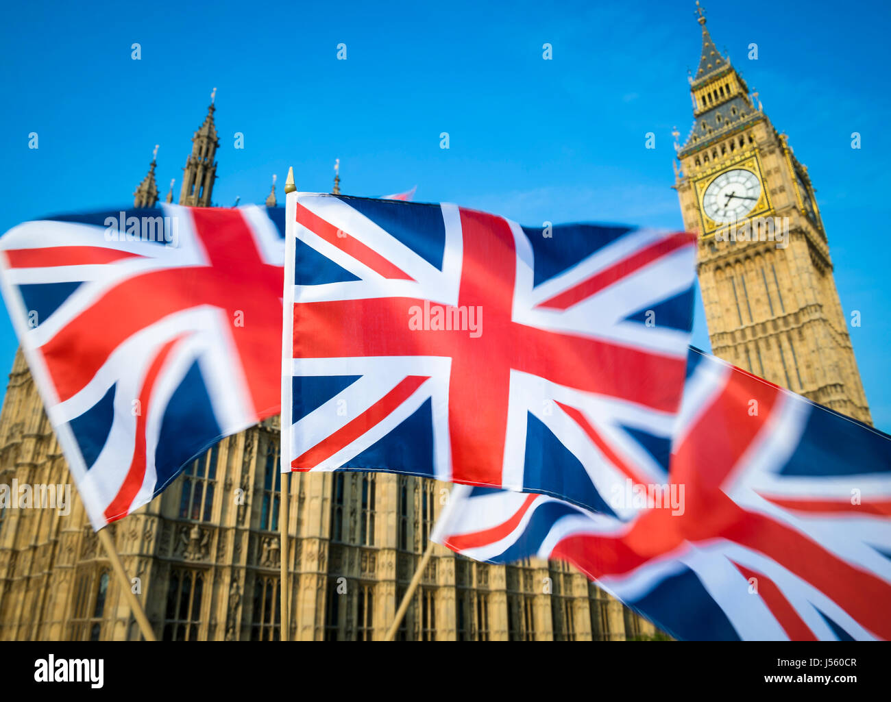 Great British Union Jack flag sflying in motion blur in front of Big Ben and the Houses of Parliament at Westminster Palace, London, UK Stock Photo