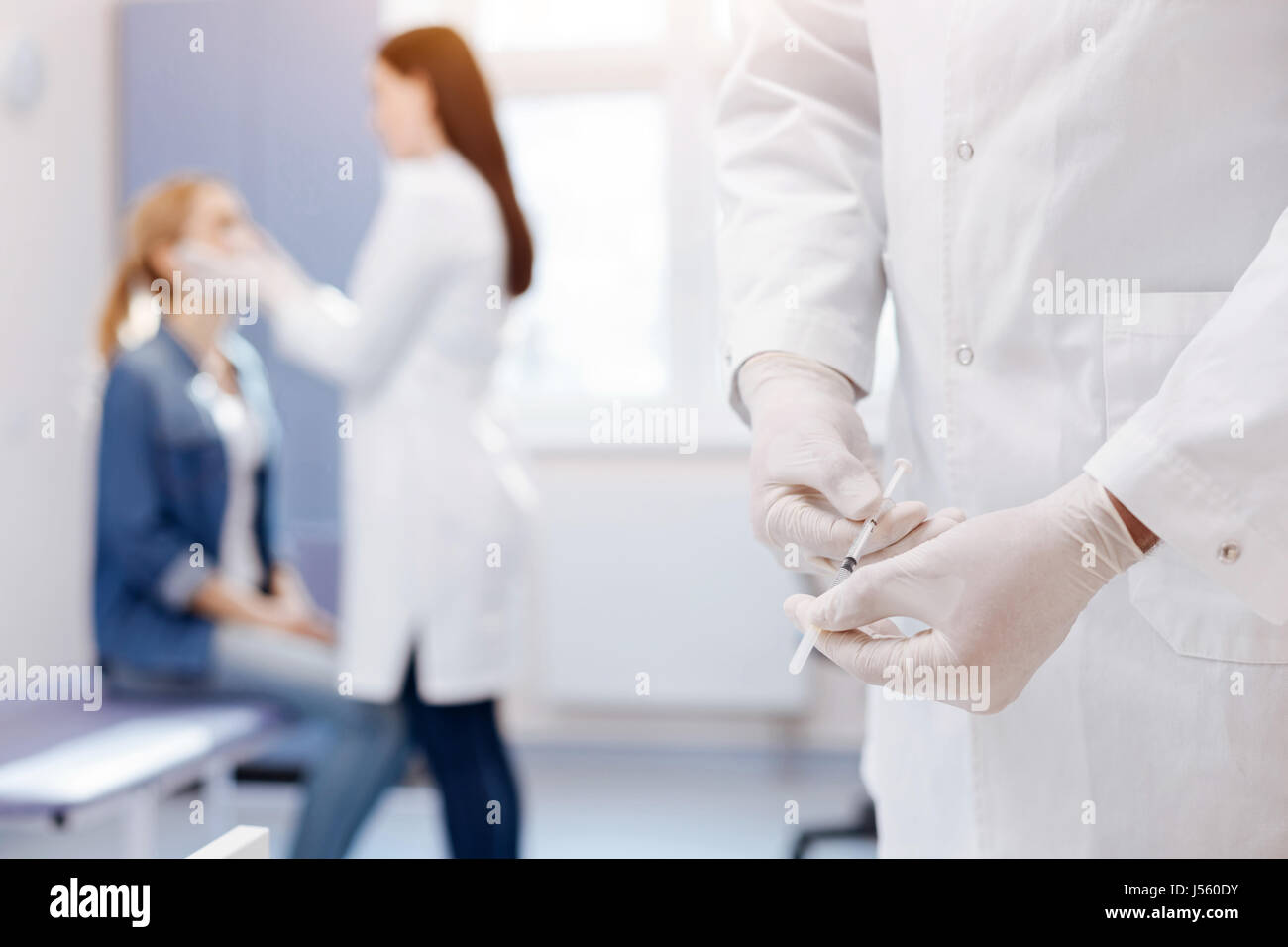 Nice professional doctor preparing to do an injection Stock Photo - Alamy